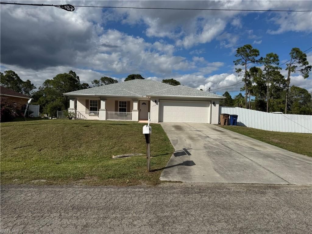 Photo of 1065 Lilac Street E, Lehigh Acres, FL 33974 (MLS # A4648894)