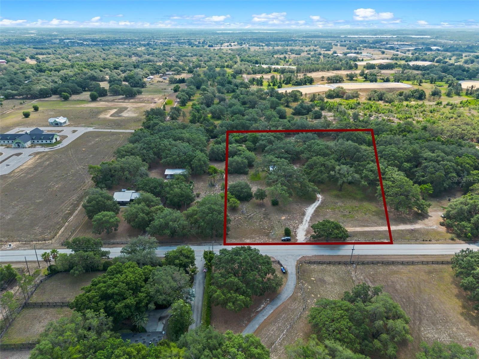 Stunning canopy of oak trees will compliment your new custom home on this 4.59 acres of land; builder and plans available upon request with no timeframe to commence construction. No HOA and no rear neighbors. Plenty of room to spread out, farm and garden. Much of the property has been cleared and has continually been maintained. A well was installed to offset any landscape watering costs. Horse trails available behind the property. Location close to the 429 for commuting to Orlando or towards Tampa. Property currently zoned agricultural.