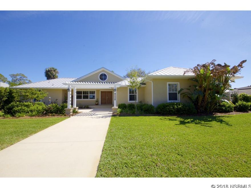 WATERFRONT BEAUTY!  This custom home, built in 2006, has an open floor plan with plenty of windows that showcase one of the BEST views on Turnbull Bay.  Wake up to spectacular sunrises and watch the dolphins play while you enjoy the privacy of the back porch.  Fish from the dock or take your boat out into the bay and out to the intracoastal.    This home has 3 bedrooms total, with the third bedroom currently being used as an office, plus two bathrooms.  Inside this beautiful home is an electric fireplace, security system, custom wood cabinets, indoor laundry, and tile floors. Upgrades to this home are plentiful, including a dock, with 2 covered boat slips, and fish cleaning table.  A salt water pool, screen enclosed,  built in 2013, with solar heat and jet automatic cleaning system, and outdoor private shower.  A deep water well (NO water stains) and irrigation system. New A/C in 2016, built-in ceiling speakers in great room and covered back porch, outdoor TV connection.  A completely fenced yard with remote controlled gate.   The  over sized garage is big enough for a full sized truck and car, with room for your lawn mower or golf-cart.  Mature private landscaping surrounds the home. With 1.26 acres, there is plenty of room for your RV with RV electrical hook up. It has ALL hurricane proof windows, including the over sized hurricane reinforced garage doors.  Located on a dead end street. Survey is available, which was completed before the pool installation. ;Water: City