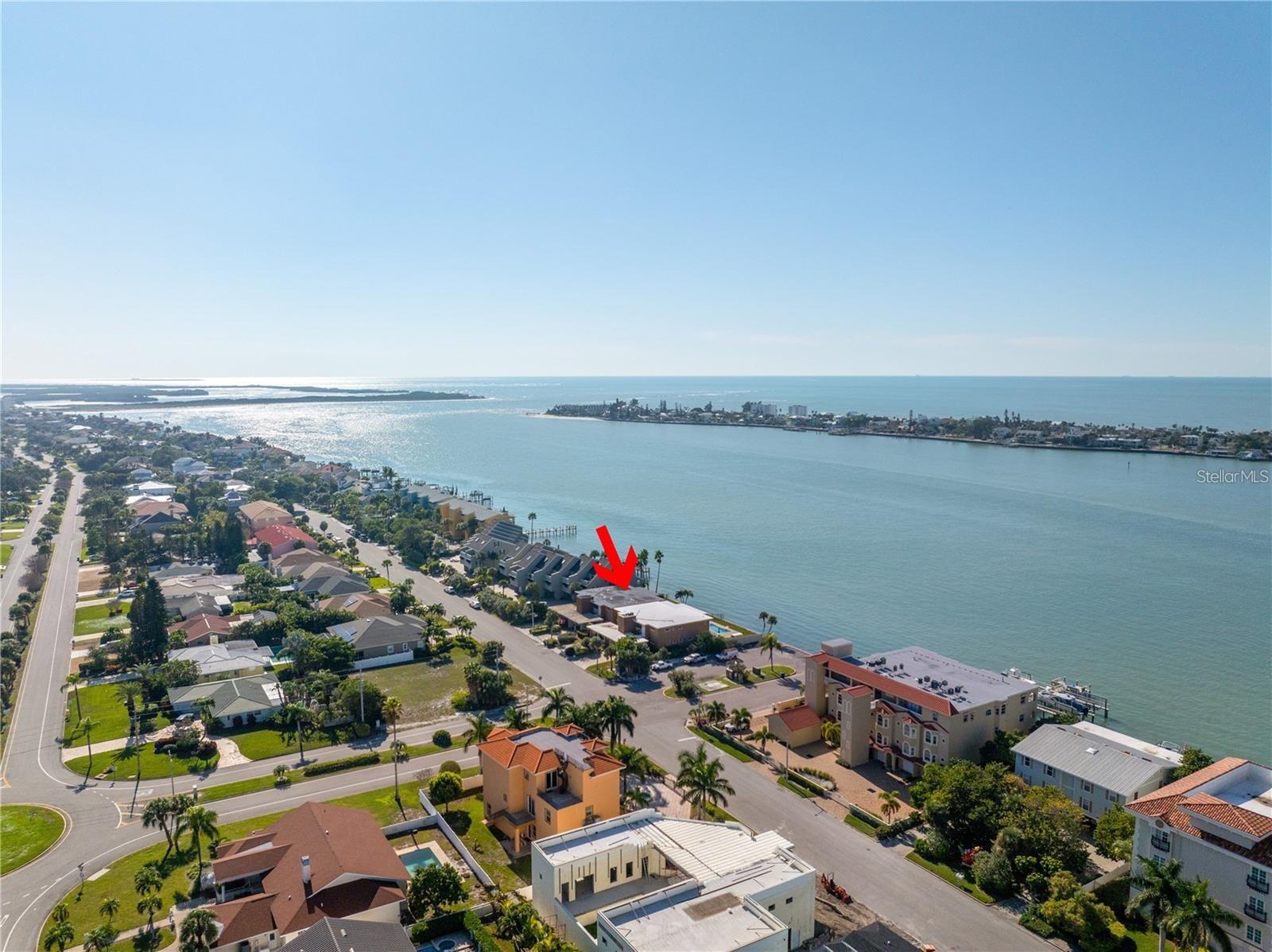 Rare Opportunity to Purchase this Stunning Waterfront Condo in Paradise. Situated in the One of the Most Exclusive Waterfront Communities in Tampa Bay on an Island called Tierra Verde, where Fort Desoto Beach - "Voted one of the Best Beaches" is just a Bicycle ride away. Overlooking the Pass-A-Grille Channel, it leads out to the Gulf of Mexico. This Upscale Condo has so many well-appointed upgrades. Special Features include: a Dream Kitchen with Cherry Cabinets, Stone Granite Countertops, Stainless Steel Appliances, Beautiful Wood Flooring in the Kitchen, Dining Room & Hallway. The Living room, Florida Room and Bedrooms have Ceramic Tile Flooring. Primary Bedroom has its own Primary bathroom with a spa tub/shower. Both bedrooms have plantation shutters. Crowning Molding in the Living room & Dining Room. Lots of Closets and storage. Ceiling Fans thru-out, a Brand-New A/C installed in May 2024 & Inside Laundry. All on First Floor so No stairs. Large Community Pool with Wide Water Views and a large patio for entertaining. Watch the Dolphins, Manatee's and Boats go by. Covered parking space & a room for your 2 cars in your driveway. All you need is here. Go for walks in this Beautiful Neighborhood, surrounded by multi-million-dollar homes, restaurants, shopping, boat rentals, bike paths, tennis, playground and Shell Island Beach for collecting shells and so much more. Public and Private Golf Courses close by. Downtown St. Petersburg is minutes away for all the art, culture and entertainment plus Tampa International Airport is 30 Minutes away. One Month Rental Rule. This Condo is priced below value! Treat yourself to something special.