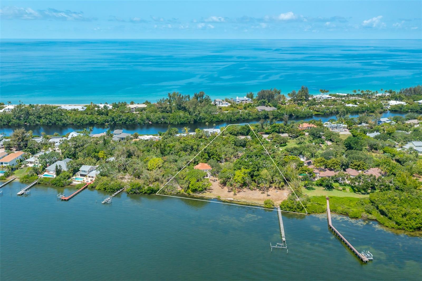 This 3.7-acre property of old Florida beauty with 346 feet of shoreline is one of the largest estates on Siesta Key with wide bay views. This is a rare opportunity to develop and build your own compound on what is one of Siesta Keys last large available properties. Currently on the property you will find a 2,200 SF guest house with an attached 4 car garage for a total of 4,626 feet of total space, leaving ample room for a large bayside residence to be built. A professional tennis court as well as a 200-foot, 5 foot wide grandfathered-in boat dock are the other main features of this property. The estate has been owned by the same family for over 30 years. The property is currently platted for 3 homes on the bayside and one across the street on Heron Lagoon. Photo renderings are for illustration purposes only and should not be used as representation of the home's precise or actual features. Call today for more information.