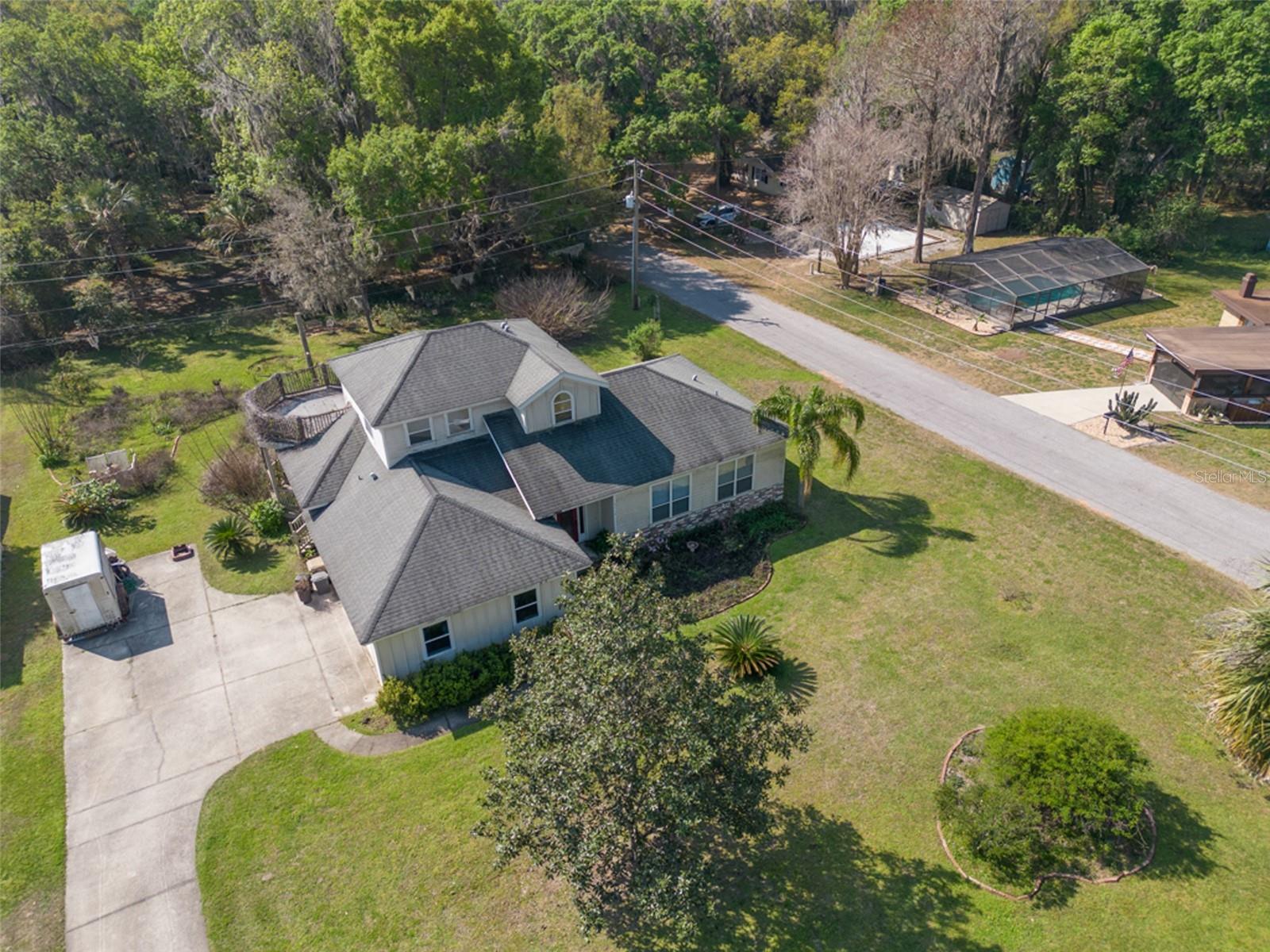 You won't want to miss this beautiful custom built home situated near Lake Harris with over half an acre of land. NO HOA! There's a Public boat ramp for Lake Harris right around the corner! This home has a custom layout with a large open floor plan downstairs. The large great room is bright and welcoming and the kitchen overlooks both the great room and dining area with all having views of the beautiful backyard. The high ceilings and custom finishings add to the beauty and character of the home. The upstairs master bedroom provides a private oasis with a large updated bathroom including a jacuzzi style tub, large shower, a walk in closet and even a bidet. The master also has its own private balcony! The other two spacious bedrooms are downstairs and near a full bath. Great for other family members, guests, or even a home office. The oversized laundry room is located on the first floor and can even double as a craft room or extra storage. The large wood deck at the back of the home is great for entertaining and relaxing. The kitchen has granite countertops, custom cabinets and a double oven. The home also includes a tankless hot water heater - so no more waiting for hot water! Come and see this one of a kind house and lot ASAP as it won't last long.