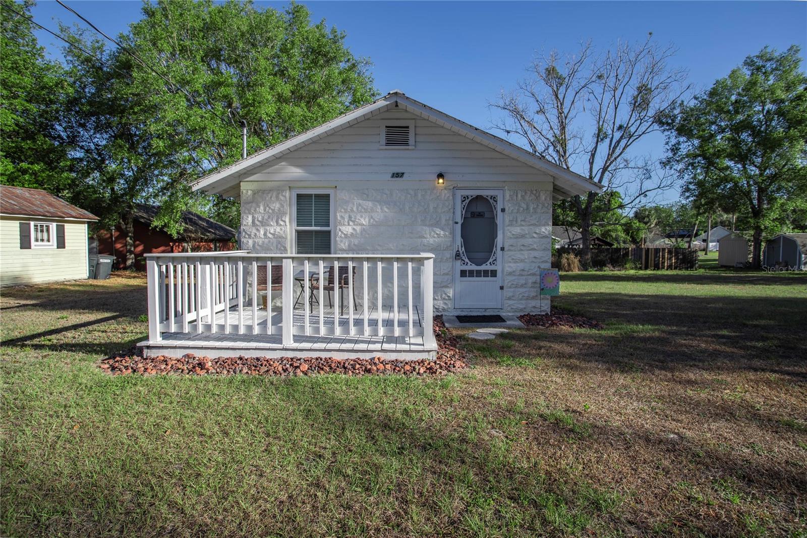 This sweet little cottage is best described as a studio with a full kitchen, full bath, closet and outside washer and dryer. It comes with a lot with a shed for storage and a buildable lot zoned R2. Seller will not sell separately. The cottage is fully furnished with linens, washer, dryer, dishes and all furnishings. This has been a rental and also used as a vacation rental through VRBO.