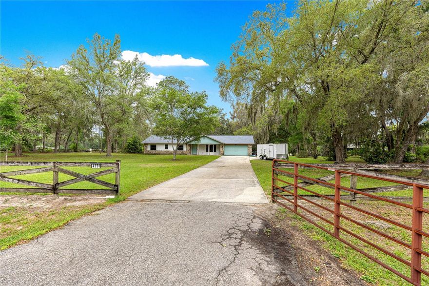In town location with privacy feeling on 1.87 Acres | No HOA | SE Ocala Lifestyle Property located in the sought after Kozick Subdivision.
Welcome to your private slice of Central Florida living! Situated on 1.87 acres of A-1 zoned land, this beautiful ranch-style home offers the perfect combination of space, flexibility, and convenience. 
Step inside to find a refreshed interior with updated finishes and a functional layout designed for comfortable everyday living. Natural light fills the home, creating a warm and inviting atmosphere. This functional layout offers a galley kitchen with stainless. appliances and inside laundry. Light and bright family room with brick fireplace, this room steps into an inviting sun room with infrared sauna. 
Outside, the possibilities are endless. With nearly 2 acres of usable land and no HOA restrictions, this property is ideal for RVs, boats, equipment, the property comes with RV hookup as well as a generator plug.  Room to add workshop or greenhouse. Whether you’re looking for privacy or room to expand, this property delivers. Located in desirable SE Ocala, you’re just minutes to downtown Ocala, shopping, dining, healthcare and major roadways—while still enjoying peaceful surroundings.
Don’t miss this rare opportunity to own land, freedom, and an updated home all in one.