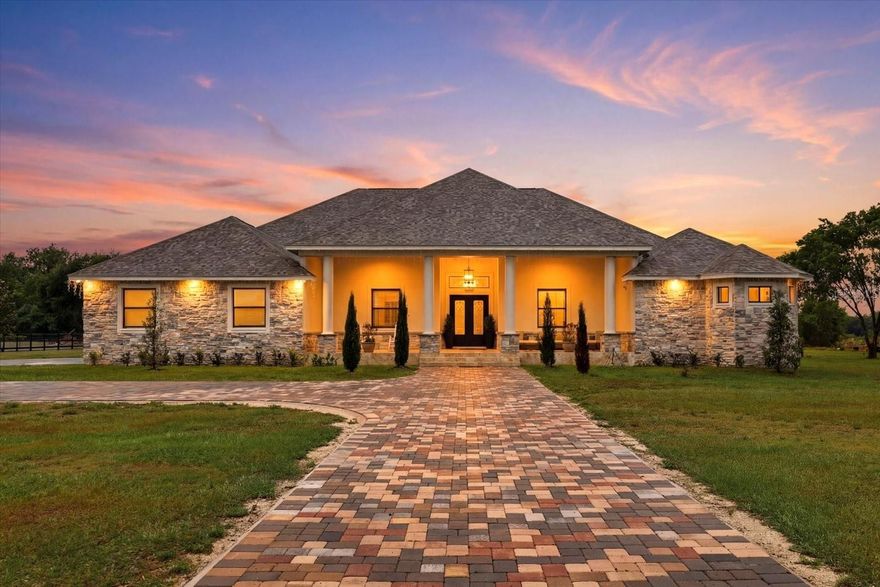 Contemporary luxury home designed for living and entertaining, featuring a private office, full home theater, and a versatile game room/gym that can easily serve as a guest suite or 5th bedroom.
The spa-inspired owner’s suite offers a private retreat with sitting area, dual custom walk-in closets, and direct access to the backyard. The owner’s bathroom is designed for relaxation, featuring a Jacuzzi tub, dual showerheads, private water closet, and dual vanities with a dedicated makeup station.
The chef’s kitchen is the heart of the home, showcasing a waterfall stone island, 36-inch cooktop, built-in oven and microwave, and a spacious walk-in pantry—perfect for everyday living and hosting.
Enjoy seamless indoor-outdoor living with sliding glass doors leading to oversized front and rear porches with custom wood ceilings, plus a fully equipped outdoor kitchen ideal for entertaining while enjoying breathtaking sunset views.
Each additional bedroom is generously sized with its own private bathroom, complemented by high ceilings and 8-foot interior doors throughout.
Additional highlights include an iron double-door entry, a striking foyer with stone accents, natural elements, and a modern chandelier, as well as a spacious laundry room with ample storage. All designer chandeliers convey.
The 3-car garage offers flexibility to accommodate up to 4 vehicles and includes built-in storage. A paver driveway extends from the entrance, enhancing curb appeal and functionality.
No HOA. No CDD. Enjoy privacy, space, and luxury living in a peaceful setting.