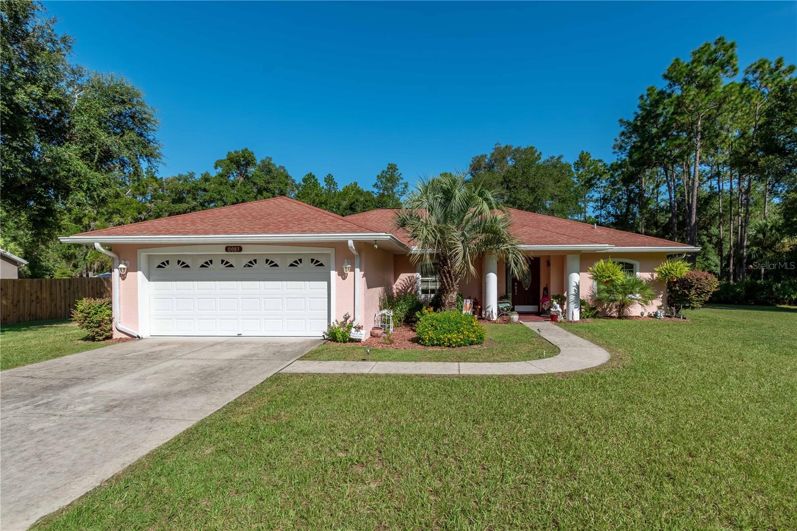 Tucked away on over half an acre in Crystal River’s Crystal Manor neighborhood, this well-maintained 3-bedroom, 2-bath home blends everyday comfort with hobby-ready extras. With recent updates including a new well pump and septic servicing in 2025, this home is both practical and inviting. Surrounded by tasteful landscaping and large yards, the home provides lots of curb appeal and a covered entryway. Featuring a total of 3-bedrooms and 2-baths, the home is light and bright with over 1,600 sqft of space throughout. The kitchen is well-equipped with ample cabinet and counter space, stainless steel appliances, a breakfast bar, and an adjacent nook for casual dining. The bright and open living room features sliding glass doors that lead directly to the screened pool area, creating seamless indoor-outdoor flow and flooding the space with natural light. Additional highlights include built-in pest control tubes, an irrigation system, and thoughtful upgrades throughout. The primary suite offers a quiet retreat, while two additional bedrooms provide flexibility for guests or workspace needs. At the back of the home is a sparkling screen-enclosed pool with a large pool deck and covered seating area, a wonderful option that makes it easy to enjoy the year-round sunshine. Out back, a detached 30x60 garage is a dream setup for hobbyists, mechanics, or anyone in need of serious storage. With 220 electric, lighting, water, a 4-ton car lift, and its own climate-controlled man cave, the space is well-equipped for projects of all kinds. There’s also an 8x10 insulated metal shed with electric—perfect for tools or small equipment. Located just minutes from Lake Rousseau, you’ll enjoy quick access to public boat ramps, scenic boardwalks, and some of the area’s best freshwater fishing. A short drive to the Gulf Coast opens up even more opportunities on the water. Whether you’re looking for a primary residence or a weekend getaway with room to tinker, this property offers comfort, convenience, and space to make it your own!