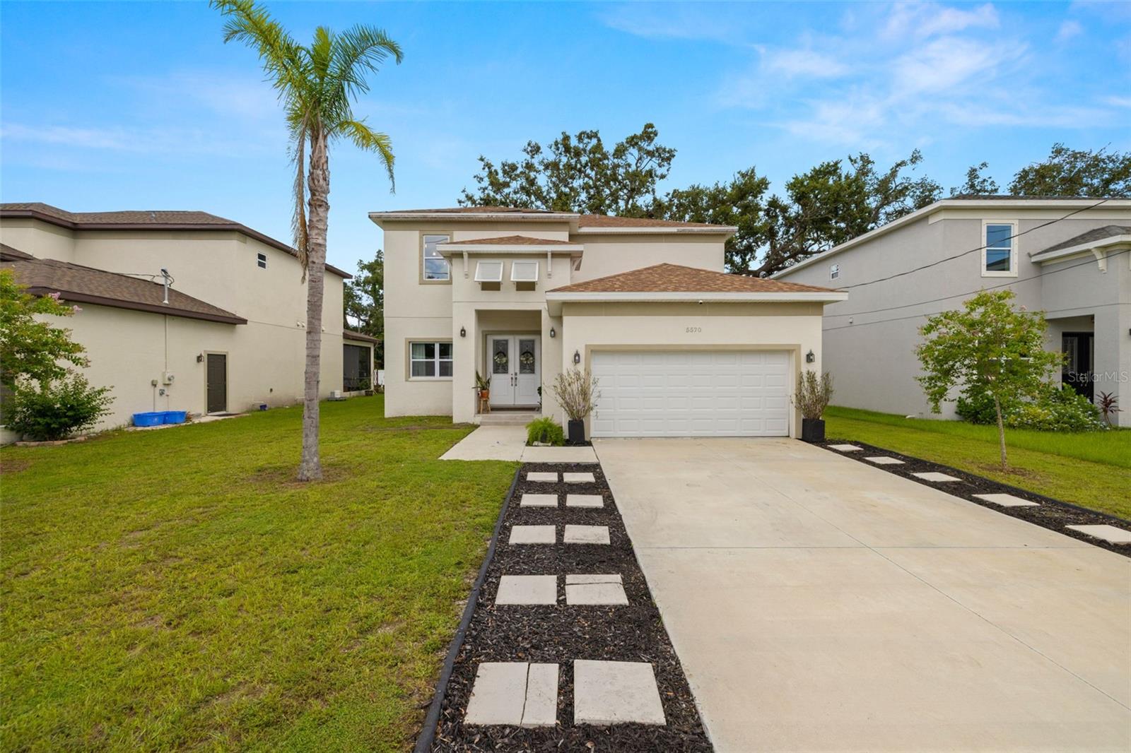 Step into a world of refined living at this nearly-new 2023 luxury residence, offering 2,859 square feet of impeccably designed living space in the heart of Pinellas County. Nestled on a high-and-dry, NON FLOOD ZONE lot, this architectural gem features 4 expansive bedrooms, 3.5 spa-inspired bathrooms, and a layout crafted for both grand entertaining and everyday elegance. One of the home’s most desirable FEATURES IS THE FIRST-FLOOR PRIMARY SUITE, a serene retreat offering dual walk-in closets, a beautifully finished en-suite bath with double vanities, and upscale Delta fixtures—perfectly positioned for privacy and convenience. From the moment you arrive, the home makes a striking impression with its sweeping front lawn, dramatic double-door entry, and a 22-foot vaulted foyer that sets the tone for the sophistication within. The main living area flows effortlessly in an open-concept design, filled with natural light and thoughtfully connected to the kitchen and great room for seamless everyday living and entertaining. The designer kitchen showcases modern cabinetry, granite countertops, premium fixtures, and a spacious island—ideal for gatherings both large and small. Upstairs, a versatile loft space is flanked by three oversized guest bedrooms, two full bathrooms, and a thoughtful split layout offering comfort and privacy for family and guests. Step outside to your own private backyard oasis, complete with a covered lanai, custom paver patio with pergola, and a built-in firepit—ideal for al fresco dining, outdoor lounging, or cozy evenings under the stars. Additional highlights include double-pane windows for improved energy efficiency and comfort, as well as a spacious double garage with ample room for vehicles, storage, or hobbies. Set on nearly a quarter-acre lot in a quiet residential enclave with no HOA or CDD, this home seamlessly blends modern construction with timeless design. Ideally located just 15 minutes to vibrant Downtown St. Petersburg, 25 minutes to Tampa International Airport, 20 minutes to St. Pete–Clearwater International Airport, and only 30 minutes to world-renowned Gulf Coast beaches, this home offers a lifestyle of convenience, luxury, and connection. Luxury suburban living—redefined.