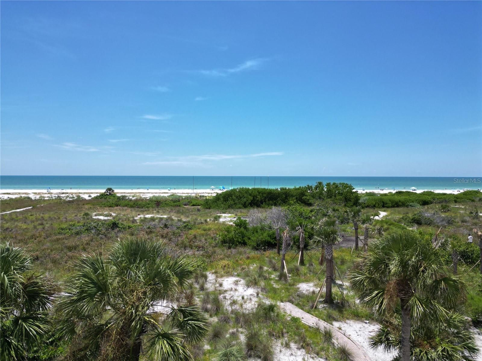 This beach front opportunity in spindrift does not come around often! With a prime Siesta beachfront unit within a three building, six unit complex that is only a five minute walk from Siesta key village. If you're looking for your own quiet place away from tourist crowds and large associations, then this unit is for you. This unit overlooks the pool with the stunning backdrop of your own piece of Siesta Beach. The unit is on the second floor. The two over-sized bedrooms that pair with two bathrooms just need a little updating. The nice sized kitchen needs a little renovation and paint color of your choosing to create your perfect home. The open floor plan boasts a lot of space for a family gathering nestled around the wood burning fireplace; leaving enough room for a large dining area. The A/C is 2021. New vinyl wood flooring and brand new roof installed 2025. New hardy board siding is set to be installed as well as a new window to be installed upon permitting. Two sliding glass doors that lead to a wrap-around balcony for a panoramic view of the neighborhood and beach front. Around the corner you have Siesta Village full of your shopping desires, Beach bars to fulfil your thirst, and your favorite local restaurants that ties in your perfect beach vibe.