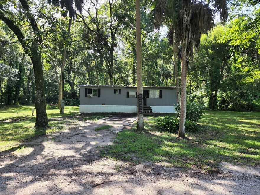Pictures are from a previous listing of the property. NO HOA and NO CDD!! This can be an investment Property or a first home. If you want privacy, you get it here. Currently occupied month to month so you can move in soon or find a renter to have residual income. This manufactured home is in a country setting, sitting on over an acre at the end of a dead-end road. It has oak trees, short and tall palm trees that shade the yard. It also has a creek on the property with the sounds of the water falling into the creek is very tranquil after a rain. You own the property past the creek as well. Public Records show the size of the property. Survey will be needed to know the true property lines. Come see for yourself. The home is found near I-4 and Hwy 60, so you can get to everywhere quickly.