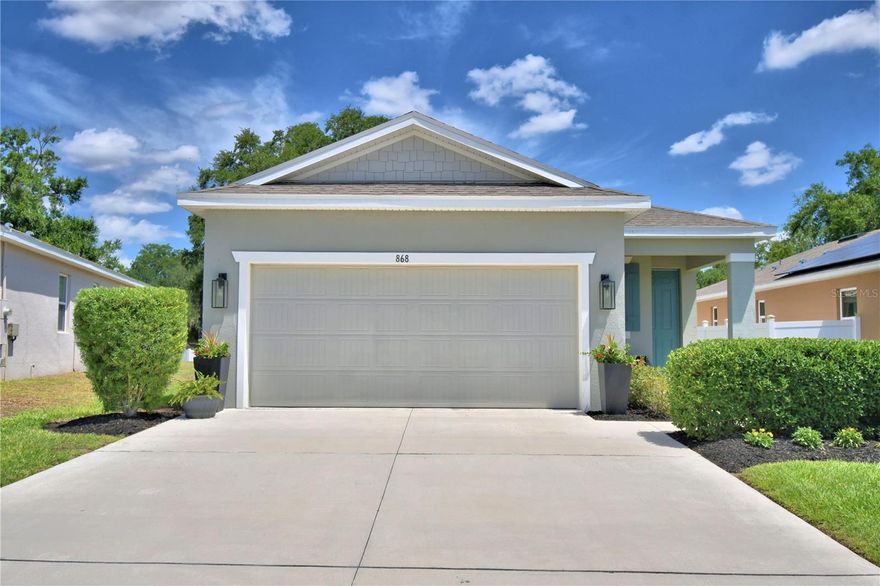 The heart of the home is in the polished kitchen! Beautifully maintained, modern, 3-bedroom, 2-bath home featuring a desirable split-bedroom floor plan and an open-concept modern flair living, dining, and kitchen area—perfect for both everyday living and entertaining. Enjoy relaxing mornings on the covered front porch with space for a cozy seating area, or unwind on the screened back porch overlooking the yard. The windows have been tinted except bedroom and sliding door.

Upon entry, you’re welcomed by a convenient mudroom that leads directly to the two-car garage. Just off the kitchen, a private hallway offers access to the laundry room, two secondary bedrooms, and a full hall bath—ideal for guests or family.

The heart of the home is the stunning kitchen, complete with a large island featuring seating, a built-in sink, dishwasher, and ample cabinet space. The kitchen has a large pantry for storage. The kitchen flows seamlessly into the spacious living area, creating a bright and inviting atmosphere.

Tucked away for privacy, the generous primary suite boasts a luxurious ensuite bathroom, providing a peaceful retreat at the end of the day.

This home feels like new and has been exceptionally well cared for—move-in ready and waiting for its next owner! Property is partially fenced and should be easy to connect for a fully fenced back yard.
