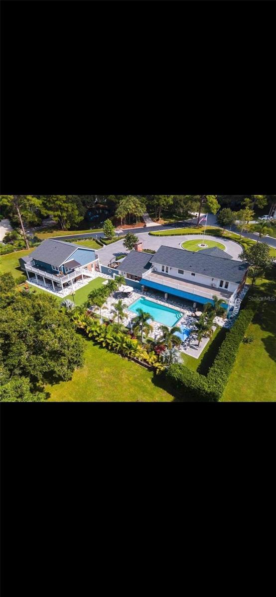 Approached by an expansive block paved driveway with parking for 20 plus vehicles. Ten, 260 year old antique British bollards (originally Napoleonic cannons) lead you to this well-proportioned family home with a separate luxury mother in law apartment.
This estate style home sits on a private and expansive 1.3 acre lot with screened patio and large pool area for total privacy. Beyond are gardens with beautiful Oak, Pine and Avocado trees which bare fruit annually.
Upon entering the property, the grand entrance hall offers Carrara Marble floors and a stunning chandelier on Jeanie Lift for easy cleaning.
The exceptional flowing floor plan leads you to the Chef’s eat in kitchen with well appointed integrated professional appliances including full gas range and center island with a radiant blue semi precious counter top.
Adjoining this via the custom elliptical arch is a large family room with grand brick fireplace with LP gas.
Extensive bookshelves, custom paneling that leads you access to an English style courtyard with hand carved stone paving slabs and ornamental railings.
The ground floor also boasts a large bright formal living room and dining room with impressive elliptical arches and ceiling features. A guest powder room, den and large utility room/mud room complete with fitted pantry and housekeeper’s desk area. Pool shower room leads to the 900 sqft Summer Room with a professional outdoor kitchen, fireplace and dining & entertaining space. Encapsulated by electrical screens and extensive landscaping.
The first floor comprises the large 27’ by 14’ principal bedroom suite.
The first floor also includes two further bedrooms, one of which was used as a kids tv room and a second fully appointed bathroom. There is also a second staircase with easy access to the family room. Bedrooms enjoy stunning views over the gardens.
Outside the beautiful screened pool area is designed with low maintenance in mind with artificial turf and mature shrubs and palms. The large swimming pool enjoys all day sunshine.
To the front is the huge circular driveway a 35’ commercial flagpole with lighting. The 3 car garage is complemented with an attached gym with a powder room.
Staircase access to the one bedroom well appointed guest house with tray ceilings, a beautiful kitchen and bathroom with instant hot water and roll top bath with claw feet, shower and double vanities.
This home was totally remodeled in 2017 and taken back to studwork. Also during this remodel new plumbing and drainage was installed, together with new electric, Dade County hurricane windows, doors, spray foam insulation encapsulate both structures, house is wired for smart home, security cameras and security system. Topped off with new roof’s in 2020.
There are also plans for an additional 10 car garage available to the buyer, along with possible creative financing.