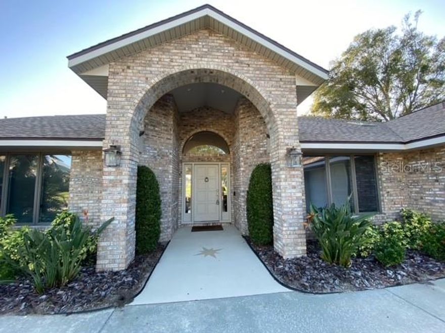 ELEGANT EXECUTIVE LAKEFRONT HOME on Prestigious "Island" in Sugar Mill Country Club.   This Custom-Built BRICK, 3-Bedroom (Office could be 4th Bedroom), 2 & 1/2-bath Home offers Speculator Views of the Blue Course 9 hole Tee Box & Fairway.  The gorgeous LAKE provides stunning view of shore birds, turtles and wildlife.  HUGE 28x15 Screened Heated Pool and Spa extends across the back of the home.  Pool area has pavers and beautiful covered area for dining and entertaining. Living Room sliders open to extend interior of home to outside pool area!  Living Room has Floor to Ceiling Brick Gas Fireplace, Built-in Bookshelves, Custom Lighting, Wet Bar and Amazing View of Pool and Golf Course! Office has Built-in Desk and Bookshelves.  Kitchen Dining area overlooks Pool and Lake. Huge Kitchen has Breakfast Bar, Island and lots of storage and cabinets.  Luxurious Master Bedroom/Bath Suite with 2 walk-in Closets.  You will love the Peaceful View of Pool and Lake from your bedroom and also that it Opens to your Heated Spa! The Oversize Garage is 812 sq ft of Workshop, Custom Built-In Storage as well as parking for two cars & golf cart. Newer roof and new Trane 5-ton HVAC in 2020. This is one of the largest lots in Sugar Mill with one of the most desirable custom homes offering true serenity in a natural preserve setting that must been seen!  Enjoy the finest of amenities offered by the renowned Sugar Mill Country Club including a 27-hole Championship Golf Course that has been certified by Audubon International as a Cooperative Sanctuary, 4 Har-Tru tennis courts, 3 pickle ball courts, state-of-the-art fitness center, saunas, a pool, and 3 onsite dining venues. All amenities are by separate club membership. https://www.sugarmillcc.com. All information contained herein is deemed reliable but not guaranteed to be accurate. All information to be verified by buyer, measurements are approximate. ;Water: City