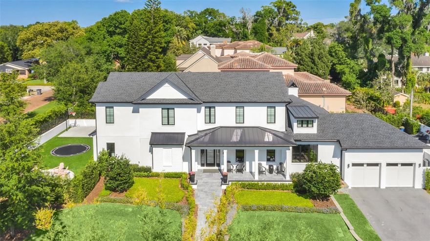 Stunning turnkey luxury home in one of the sought-after neighborhoods of Winter Park. Experience unparalleled luxury in this breathtaking four-bedroom, six-bath estate built in 2020, offering over 4,300 square feet of exquisitely designed living space. Every bedroom is a private retreat with its en-suite bath, and the home is adorned with designer finishes and exceptional craftsmanship throughout. Step into the expansive great room, a versatile space that seamlessly blends formal and casual living, featuring a glass-enclosed temperature-controlled wine room, a gas fireplace and a chic dry bar. The chef’s kitchen is a culinary dream, showcasing a massive quartz island, top-of-the-line Thermador six-burner plus griddle gas range with double ovens, a separate freezer and refrigerator, beverage refrigerator, and a spacious walk-in butler’s pantry with a built-in convection microwave and warming drawer. The primary suite is a sanctuary of luxury, featuring dual spa-like baths, a stunning soaking tub, a steam shower, a smart toilet, custom-designed dressing rooms and a hidden safe room. French doors lead to a private lanai with a seating area, an outdoor tub and a serene open-air shower. Upstairs, a spacious 23-by-15-foot family room connects three additional bedroom suites, each with its private bath. One of the bedrooms features a hidden passageway to a 12-by-7-foot bonus room, ideal as a playroom, private media space or climate-controlled storage. Designed for seamless indoor-outdoor living, a 21-by-20-foot covered lanai with a gas fireplace and motorized screens extends from the kitchen and great room via folding glass doors. The two outdoor retreats include a sun-soaked pool deck, built-in grill, firepit, turf lawn, built-in trampoline and basketball court. Additional highlights include a drop-zone off the two-car garage for added convenience. On a charming brick-lined street, this home offers prime access to Park Avenue’s premier dining and shopping, downtown Orlando, major hospitals and Orlando International Airport just 25 minutes away. A rare opportunity to own a turnkey masterpiece that offers the ideal balance of comfort style, and exceptional entertainment spaces.