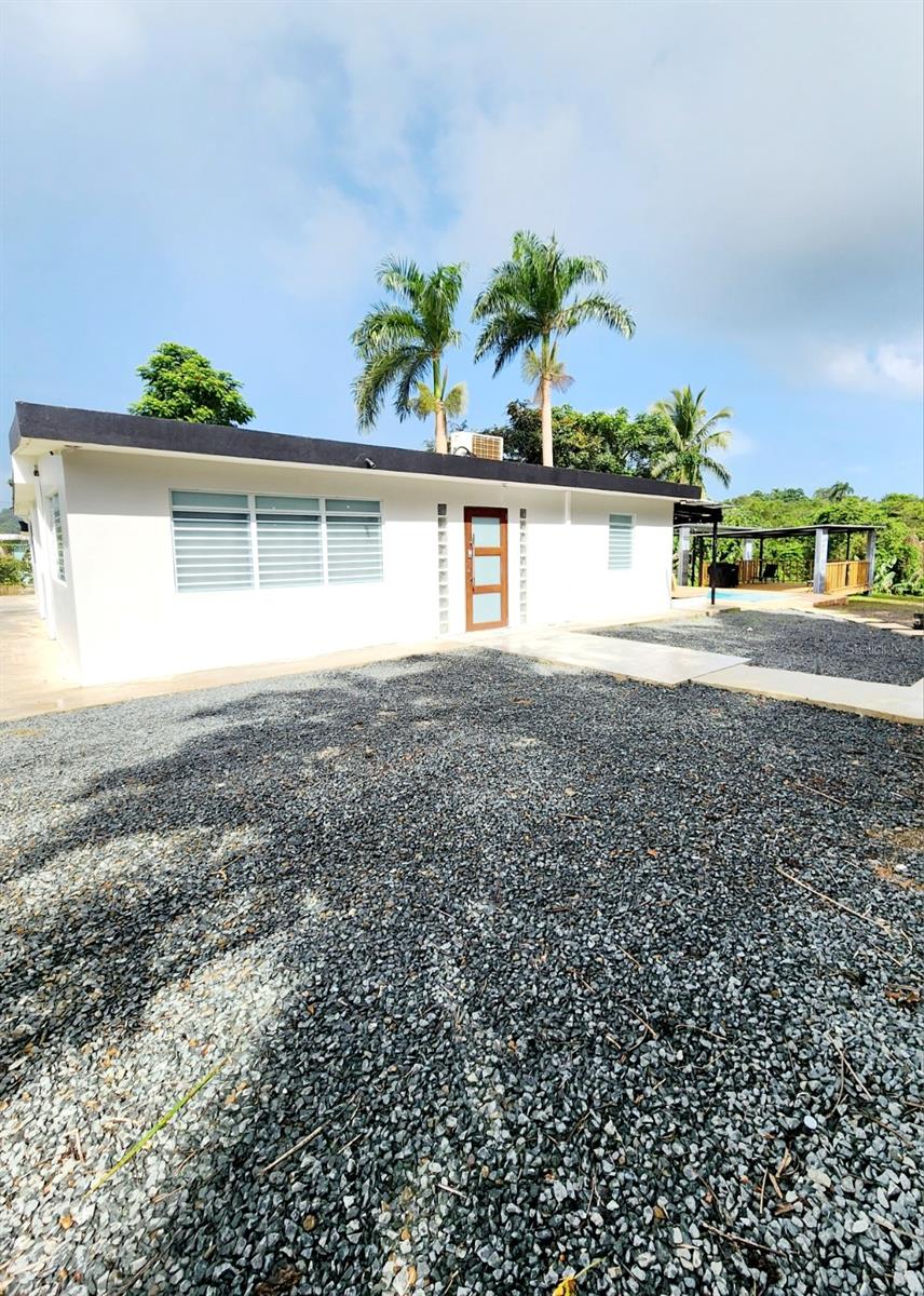 This beautiful property was completely remodeled. Brand New Generac Gas Generator installed in April. It has 2 bedrooms and 1 bathroom in the main house with PVC cabinets in the kitchen/dining room combo and living room and 1 bedroom, 1 bathroom, small living room and small kitchen with PVC cabinets in the apartment. In addition, a full bathroom and laundry area and storage room were built right across the main house exit door. It has a recently constructed brand new pool and jacuzzi and the jacuzzi has a heater. It has 1 covered and tiled terrace and 2 additional terraces, 1 with a wooden floor and zinc roof and the other one with a zinc roof and with hammocks to relax with a view of the vegetation. This property is designed for those who want to live in one and rent the other or simply rent both for short-term rentals or through regular rentals. The current price DOES NOT includes all furniture but it is negotiable. The furniture is divided as follows:
Main house: 2 king-size bedroom sets, 2 queen-size sofa beds, 1 gas stove and refrigerator, both regular size, dining room set with 5 chairs and 4 additional chairs for the counter area. 4 air conditioners and 3 smart TVs.
Apartment: 1 queen size bedroom set, with 1 queen size sofa bed, 1 small gas stove, 1 small refrigerator in kitchen, and dining set with 6 chairs, 2 air conditioners and 2 smart TVs.
The ranges and refrigerators on both, the apartment and main house are included. The location of this property is excellent, just 5 minutes from El Yunque Rainforest and about 10 minutes from Luquillo beach and with restaurants, gas stations, pharmacies and much more just minutes away. Do not miss the opportunity, call us now while it lasts.
All measurements are approximate and needs to be verified by realtor or the buyer.