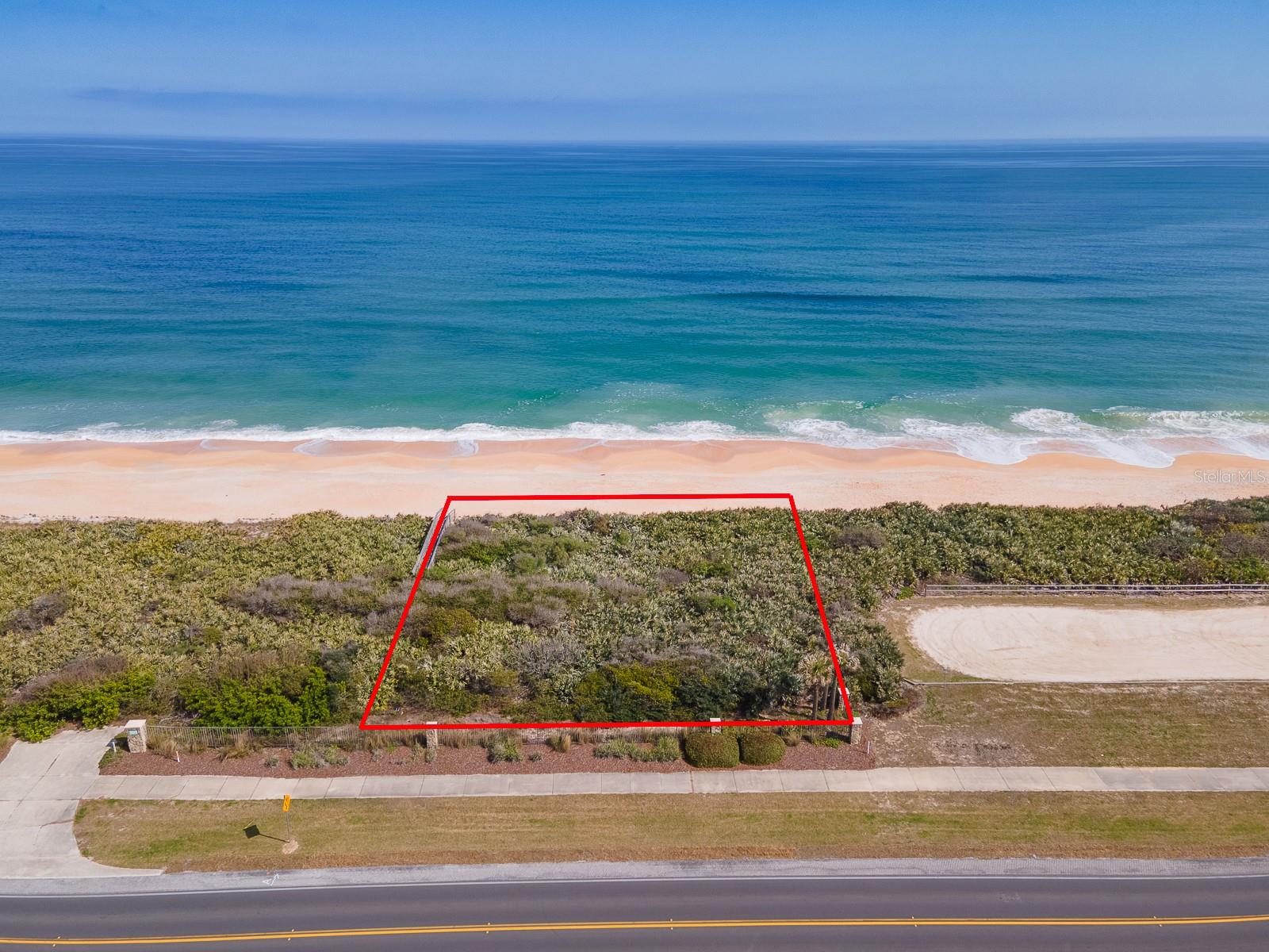 Exclusive Oceanfront Lot in Carino La Mer – Hammock Dunes, Palm Coast, FL,
Build your dream oceanfront estate in Carino La Mer, the exclusive southernmost oceanfront neighborhood of Hammock Dunes. This 100-foot-wide end lot at 3709 N Ocean Shore Blvd, Palm Coast, FL offers unparalleled privacy, with no neighboring property on one side, making it one of the most desirable homesites in the community.
Located within the prestigious Hammock Dunes community, this property is part of Ocean Estates, featuring private dune walkovers for direct beach access. The high dune provides natural protection from ocean waves, offering peace of mind while preserving the beauty of this incredible coastal location. The Hammock Dunes community owns, maintains, and protects the dune area, ensuring uniformity and long-term coastal health. Beach walkovers are also maintained by the community, providing easy and secure access to the stunning coquina sand beach.
With underground utilities in place and a private dock already installed, much of the groundwork has been completed—just clear the land and start building your coastal retreat.
Carino La Mer is known for its exclusivity and high building standards. Homes in this neighborhood are designed to comply with modern coastal construction codes, making them easier to insure and more resilient to Florida’s coastal conditions. The Hammock Dunes Design Review Committee ensures architectural integrity, with Mediterranean-style homes as the community standard.
Residents enjoy a secure, well-maintained environment, with breathtaking ocean views, abundant wildlife, and opportunities for dolphin and whale watching right from your backyard.
This prime oceanfront location is just minutes from Flagler Beach, Marineland, nature preserves, and world-class golf courses like Hammock Beach Resort. Enjoy endless outdoor activities, including fishing, boating, hiking, and kayaking, all within easy reach.
Don’t miss this rare opportunity to own a piece of Florida’s exclusive oceanfront paradise. End lots like this are exceptionally rare—secure yours today! Contact us to learn more and start planning your dream coastal home.