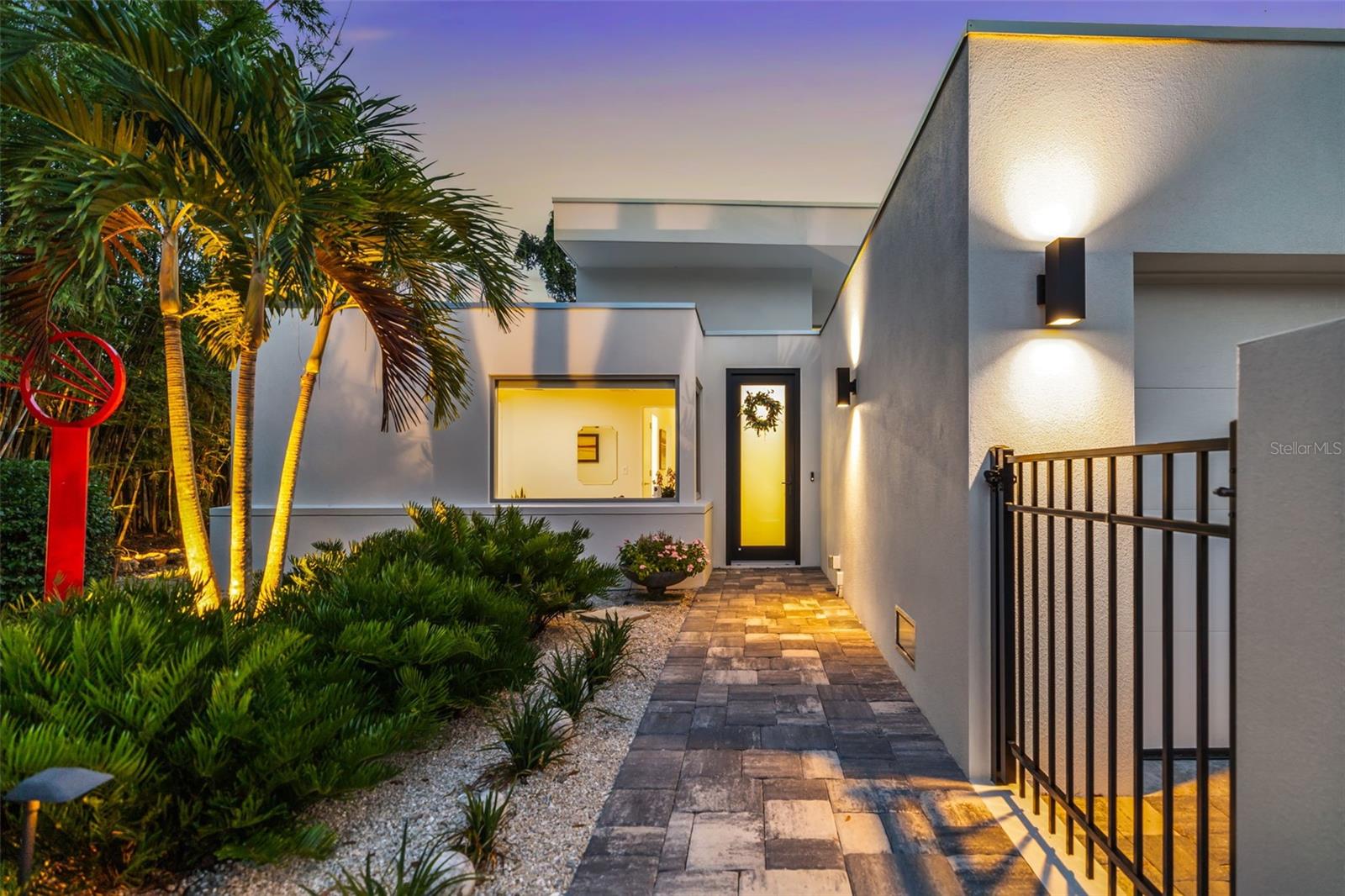 Ralph Twitchell’s Lu Andrews House #2 — An Icon of Mid-Century Modernism, Thoughtfully Reimagined
Step into Sarasota’s architectural legacy with this one-of-a-kind residence designed in 1941 by Ralph Twitchell, the visionary behind the Sarasota School of Architecture. Originally crafted for his secretary Lu Andrews, this historic home represents the first known use of stacked concrete block in residential construction—a true innovation of its time.
Located in the highly sought-after Indian Beach neighborhood and perched outside of the flood zone sitting at 16.5 feet, 904 Virginia Drive blends historic character with modern luxury across 1920 square feet of inspired living space. The home was masterfully expanded in 2009 by renowned architect James Bowen, AIA. In 2024, upgrades, including a new 2-car garage and an extended foyer entrance, as well as a third bathroom were added to complement the original design while enhancing everyday function.
Inside, you'll find a thoughtfully curated blend of mid-century elements and contemporary finishes. 3 bedrooms, including a stunning primary suite with views of the resort-style pool and gardens. Expansive great room with 16’ ceilings, wide overhangs, and walls of glass echoing the iconic Sarasota School style. Large tiled floor throughout, commercial-grade sliders, and smart power window shades. A chef’s kitchen with Caesarstone countertops, gas cooktop, and a large island perfect for entertaining. Indoor-outdoor flow leading to a private pool with a marble deck and cascading waterfall.
Other notable features include: 2021 HVAC system, alarm system and LED European lighting, whole house water filtration, on-demand tankless water heater, additional storage and landscape lighting with irrigation.
Located just steps from Sarasota Bay and minutes from Downtown, St. Armands Circle, the Ringling Museum, and Lido Beach, this residence offers architectural prestige with an unbeatable lifestyle location.
This is more than a home—it’s a piece of Sarasota’s architectural soul
