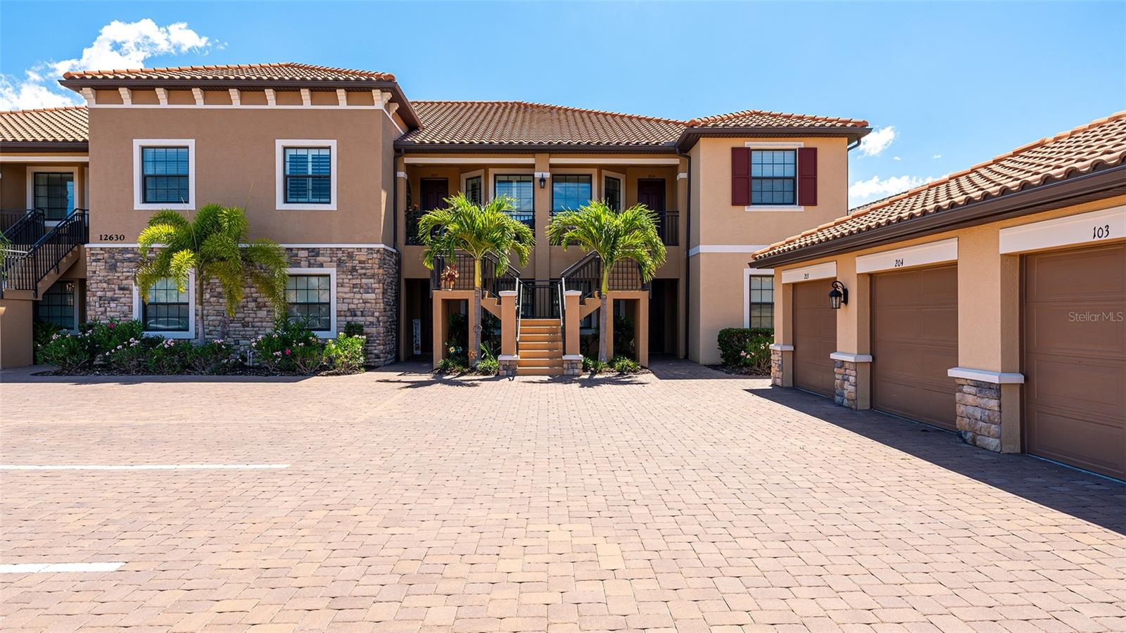 A beautiful second–floor condominium in Esplanade Golf and Country Club awaits you with spectacular views of the pristine 10th green and a surrounding sparkling pond. Enjoy resort-style amenities and a deeded full golf membership as you begin living your best life in this vibrant community. Soaring vaulted ceilings and the open floor-plan provide a feeling of spaciousness, as well as a warm and inviting ambiance for relaxation and the enjoyment of friends and family.. Recently installed luxury vinyl plank flooring in the main areas is a fantastic upgrade, as is the tall column of matching white kitchen cabinetry that enlarges the eat -in kitchen as well as providing additional storage. A breakfast nook with plantation shutters overlooks the front porch, an ideal place for taking in the colorful sunsets. The primary bedroom is en-suite with dual sinks, two walk-in closets, a large walk-in shower, and white plantation shutters. The guest bedroom also showcases plantation shutters and can accommodate a king bed. Stacking sliding doors open to the covered, screened lanai which provide the ideal spot for enjoying a coffee while watching the sunrise over the long, sweeping views of the 10th fairway and sparkling pond. A one-car garage and a parking space is included. You can experience all the advantages of the Lakewood Ranch lifestyle while enjoying the unmatched Esplanade amenities such as the 18-hole championship golf course, eight Har-Tru lighted tennis courts and eight lighted pickleball courts, bocce ball, two large resort-style pools, one with a walking resistance pool and the other with a hot tub. Two clubhouses are outfitted with fitness centers and offer an array of options including fitness classes, card games, hobby rooms, the Koquina Sand Spa, and rooms for private parties. Lakewood Ranch is the top-selling planned community in the nation. Come and live your best life!