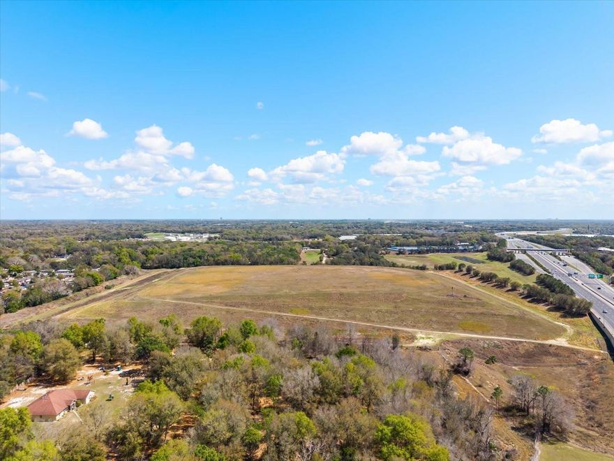 Access to the property is provided by a right-of-way off Keene Road, just west of the RC Airplane field, with an underpass beneath SR 414. Situated on the north side of SR 414, the property benefits from excellent visibility. The site was formerly utilized as a landfill and has been capped with topsoil, with monitoring wells in place through 2038. Possible future uses include solar or wind energy production, cattle grazing, or other agricultural purposes.