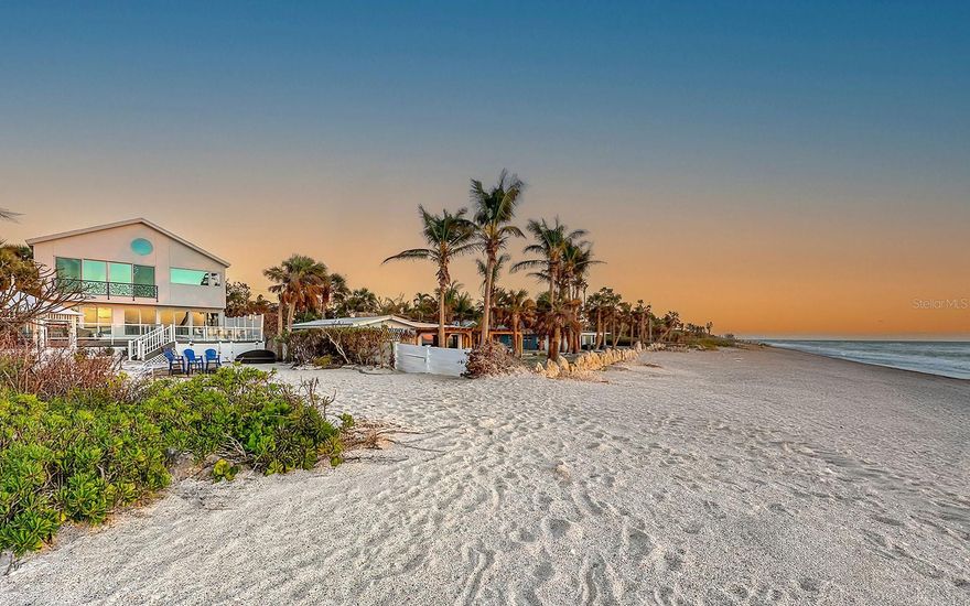 This turnkey-furnished, move-in ready, Gulf-front beach house is on private, secluded Casey Key. Fall forever in love with sunny-sky winters, year-round Florida sunsets and the magical seaside setting. This cheerful residence beams with natural light thanks to the double-height ceiling and giant windows that let Florida’s year-round sun shine in. At the heart of the 3,310 sq. ft. home is the great room/kitchen/dining area — a big, giant space where everyone can gather to cook, eat, lounge and play games together. Wall-to-wall sliders open to a bridge over the pool leading to the elevated pool deck, then down to the “Salty Kisses” gazebo along the 52-ft.-wide sandy walk to the beach. When you’re ready for indoor me-time, the primary suite on the top floor spans the entire Gulf-front side of the home and features wall-to-wall-sliders with a commanding view of the sea. Additional bedrooms include two guest suites on the main floor, a fourth bedroom on the third floor, plus a bonus room being used as a bunk room. The third floor also houses a home office and an artist’s studio. Two hand-carved Moroccan doors, hand-painted in cobalt blue by a local artist, add a touch of exotic delight to this coastal paradise. An elevator provides easy access to all levels. You’ll love the assurance that this home has had no water intrusion and has impact-glass windows and doors. Located on the south end of Casey Key, this beach retreat is just 0.7 mile to the south bridge, 2.3 miles to Nokomis Village Shopping and 3.6 miles to Historic Downtown Venice. Life is good on the beach!