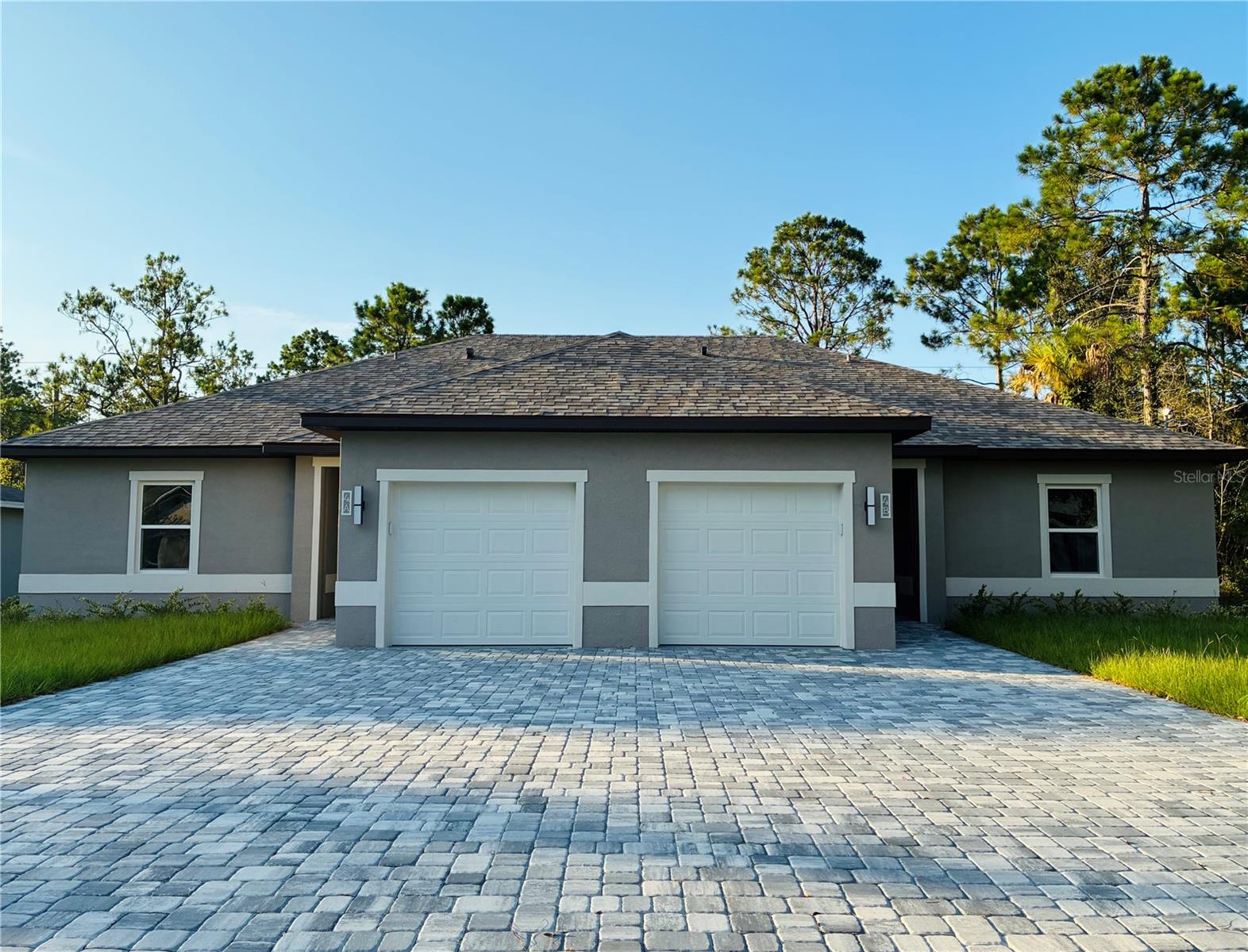 Gorgeous, brand-new 1,200 sq ft duplex unit located in the rapidly growing Seminole Woods subdivision. This spacious unit offers 3 bedrooms, 2 bathrooms, a covered rear porch, and a 1-car garage with an automatic garage door opener. The building is divided into two units by a wall with enhanced sound insulation for added privacy. The open-concept kitchen is equipped with stainless steel appliances, including a glass-top stove, 42-inch cabinets, granite countertops, and ample storage. The expansive great room provides generous space for lounging and entertaining, complemented by high tray ceilings, custom tile flooring throughout, and stylish lighting fixtures. Both bathrooms feature high-top vanities with cultured marble countertops. Ceiling fans are installed in all bedrooms for added comfort. A two-car wide paved driveway offers parking for up to four vehicles per unit.Available now! Ideal location close to schools, shopping, Town Center, AdventHealth Hospital, and just a short drive to Flagler Beach and world-famous Daytona Beach.