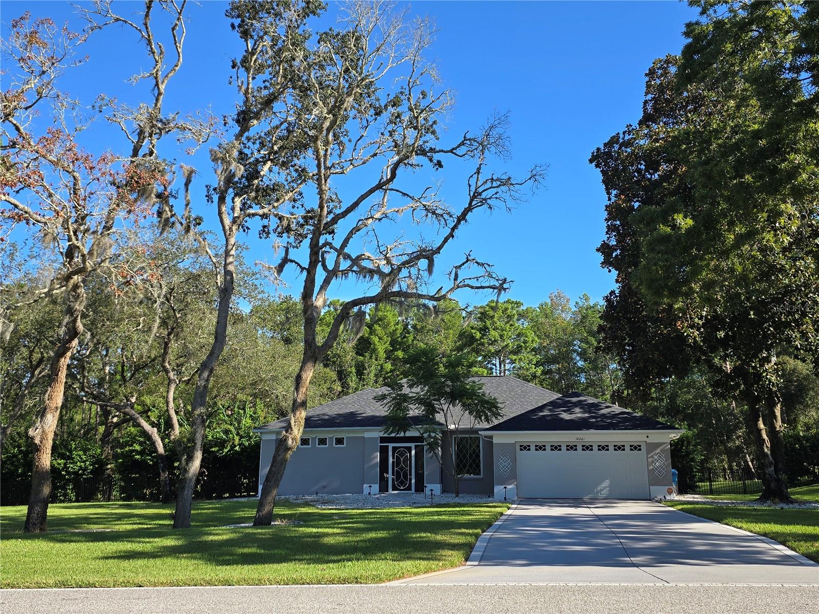 NEW !!! NEW!!! NEW!!! See the list of ALL the new updates!!! 1.80 Acres MOL with a recent appraisal for 560k.Owners are licensed broker and agent. Recently updated 4/2/2 on 1.80 acres MOL in deed restricted Woodland Waters. The community offers a private park with boat ramp access to Lake Tooke as well as tennis courts and privately maintained mailbox systems. The home has an updated roof, Trane HVAC system, smart home security system, updated bathrooms, kitchen, flooring, Sherwin Williams paint, landscaping, Samsung Elite stainless steel appliance package, custom LED lighting throughout, electric fireplace, heated pool and much more. Recently updated kitchen with granite countertops. Samsung stainless steel elite appliance package with induction stove.