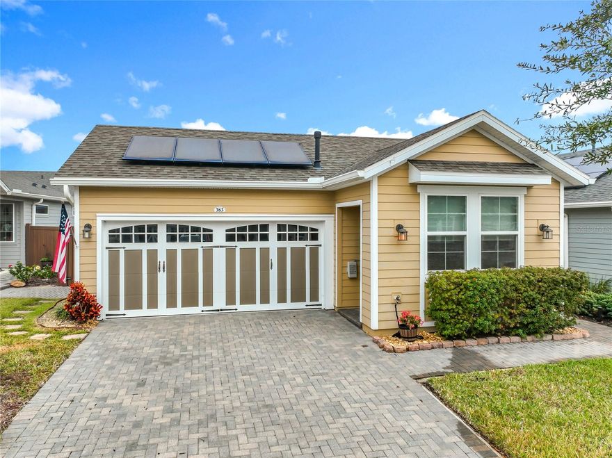 Resort-Style Living Meets Energy Efficiency in Trilogy’s Premier 55+ Community

Welcome home to this beautifully maintained villa located in the sought-after, guard-gated Trilogy 55+ community, where luxury, connection, and an active lifestyle come together. This light-filled home features an open-concept floor plan enhanced by upgraded window treatments, including honeycomb-style sunblocking shades, providing comfort and efficiency year-round.

A major highlight is the $30,000 SOLAR PANEL SYSTEM installed in 2022, which will be PAID OFF AT CLOSING —allowing the new owner to enjoy exceptionally low energy costs, currently averaging between $0 and $30 per month. Tile flooring flows throughout the main living areas, with plush carpeting in the bedrooms for added comfort.

The kitchen is thoughtfully designed with granite countertops, designer cabinetry, and seamless connectivity to the dining and living spaces—ideal for entertaining or relaxed everyday living. The spacious primary suite offers a peaceful retreat with a large walk-in closet and an elegant ensuite bath. A split floor plan provides privacy for guests with a second bedroom and bath, along with a versatile bonus room perfect for an office, hobby space, or den.

Step outside to a covered rear porch and beautifully designed side patio, all within a tastefully privacy-fenced backyard. The garden has been lovingly curated with vibrant plantings that bloom in the spring and summer, creating a colorful and serene outdoor oasis. Enjoy the best of Florida living in this golf cart-friendly community with world-class amenities.

Living in Trilogy means enjoying resort-style living with HOA-included 24-hour guard-gated security, cable TV, pools, clubhouse, fitness center, and live entertainment throughout the year. At the heart of the community is the spectacular 57,000-square-foot Magnolia House, offering a members-only restaurant and bar with live entertainment, indoor and outdoor heated pools, a state-of-the-art athletic club, artisan studios, culinary kitchen, poker room, creative spaces, tennis, pickleball, bocce, billiards, a golf simulator, numerous clubs for every interest, and a show-stopping event center with professional stage and AV setup.

Conveniently located just 45 minutes from Orlando’s world-famous theme parks and Orlando International Airport, and approximately 1.5 hours from Florida’s beaches and Port Canaveral Cruise Terminal, this home offers the perfect blend of relaxation, entertainment, and accessibility. This is more than a neighborhood—it’s a lifestyle upgrade where connection, wellness, excitement, and belonging come together every day. Live your best life at Trilogy.