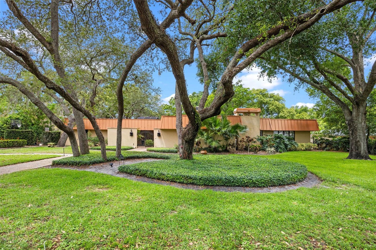 Welcome to a rarely available for rent, truly special and unique home, located in the exclusive Hidden Estates subdivision in Maitland. This expansive, single-story custom home offers over 4,000 square feet of beautifully designed living space, featuring four spacious bedrooms and four full bathrooms, plus a separate office, all set on an oversized three-quarter-acre lot on a cul-de-sac.
The open-concept floor plan is perfect for both everyday living and entertaining, with vaulted ceilings, hardwood floors, crown molding, skylights, recessed lighting, built-in cabinets, plantation shutters, and a wood-burning fireplace.
At the heart of the house is a gourmet chef’s kitchen, fully equipped with a six-burner gas stove, double ovens, a Thermador refrigerator, custom mahogany wood cabinetry, granite countertops, a large walk-in pantry, and an over-sized island with bar seating.
The luxurious master suite is a peaceful retreat with its own sitting area, walk-in closet, and a spa-inspired master bathroom. Enjoy heated floors, a double vanity, an oversized double shower, and a freestanding garden tub that offers the perfect place to unwind.
Step outside into the screened-in backyard oasis, where you’ll find a large covered outdoor kitchen and lounge area, and an outdoor movie screen, perfect for entertaining. The heated saltwater pool and jacuzzi feature a beautiful waterfall and there is a children's playground in the fully walled-in backyard. Additional highlights include a metal copper fascia roof replaced in 2018 and a new drain field in the septic tank. The location is ideal—just 10 minutes from the Altamonte Mall, with easy access to shopping, dining, parks, and excellent schools.
This exceptional property combines timeless elegance, modern luxury, and a prime location. Don’t miss the opportunity to lease this gorgeous family home!