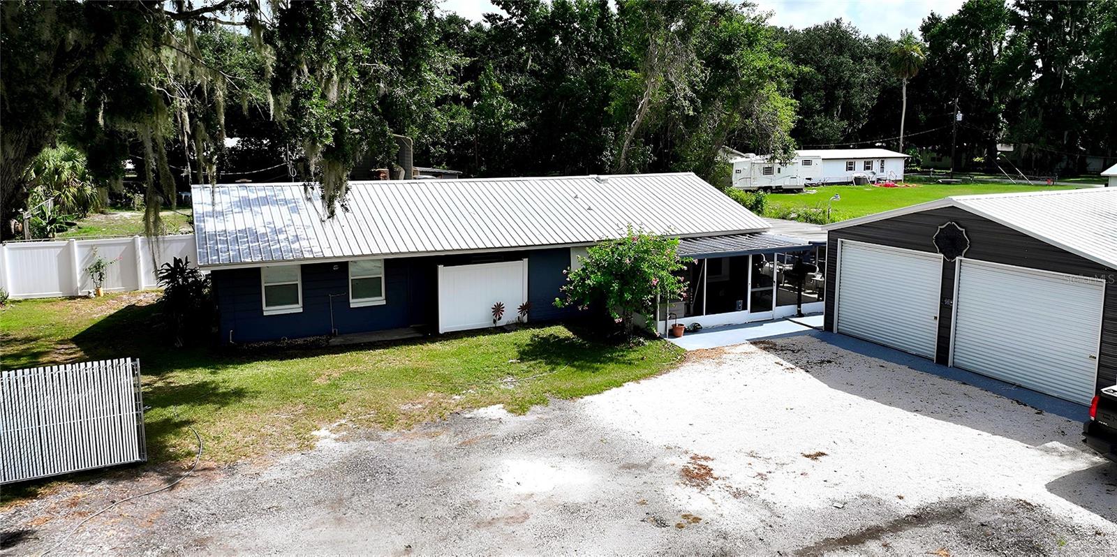 Welcome to your dream retreat! This beautifully remodeled 2-bedroom, 2-bathroom canal-front home is the perfect blend of charm and modern convenience—with the potential for a third bedroom. Nestled in a peaceful tropical setting, this home has been completely remodeled and is move-in ready, ideal for full-time living, a weekend getaway, or a lucrative Airbnb investment. The home has been freshly painted inside and out. Step inside to find gorgeous granite countertops with ample kitchen storage, darling bathroom remodels, and a bright, open layout designed for comfort and style. New Windows and Doors. Water Filtration System and Tankless Hot Water Heater. Outside, enjoy Florida living at its best with a brand-new concrete patio, new concrete retaining wall, 31 x 12 screen wrap-around patio, and a fully fenced yard—perfect for entertaining or relaxing by the water. Practice your angling skills right from the comfort of your own home. You'll love the oversized detached garage, offering plenty of space for storage, a workshop, or potential conversion. Landscaping includes fruit trees, tropical trees, and plants. Whether you're boating from your backyard or exploring nearby attractions, the location is unbeatable—just a short, easy drive to both Tampa and Orlando. Don’t miss this rare opportunity to own a slice of paradise—schedule your private showing today!