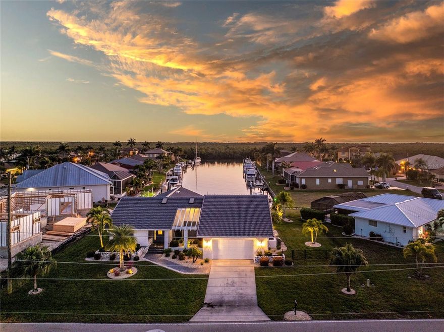 Welcome to your dream home in desirable Punta Gorda Isles! This beautifully remodeled residence features a spacious layout with 2,033 square feet of living space under air, showcasing a seamless blend of modern style and comfort. Upon entering, you’re greeted by a spacious great room and dining area where vaulted ceilings and a skylight flood the space with natural light, offering an immediate, stunning view of the lanai, heated pool, and the gorgeous long canal beyond. The heart of the home is the recently updated kitchen, complete with solid wood cabinets, luxurious granite countertops, and a large center island perfect for entertaining. Enjoy cooking with top-of-the-line stainless steel appliances, and a convenient pocket window pass-through that opens to the inviting lanai. The chic subway tile backsplash and stylish range hood add an extra touch of elegance, complemented by a generous wall of cabinets for all your storage needs.
Retreat to the primary ensuite where you'll find soothing soft blue wood cabinets and quartz counters, along with a walk-in tiled shower that creates a spa-like atmosphere. For a fresh bright look the additional full guest bath also has wood cabinets with quartz counters while the half pool bath and laundry room feature wood cabinets with granite counters - all beautifully remodeled.
Step outside to the amazing brick paver lanai, complete with a large covered area ideal for relaxing or entertaining, and a heated pool that overlooks a serene long canal view. This outdoor space with a southern rear exposure  is perfect for enjoying the beautiful Florida weather. 
Other notable features include a brand-new roof (2023), a new dock and boat lift for easy access to the water, the peace of mind of a re-piped home, and impact windows for added safety. With fast access to Charlotte Harbor via Buckley's Pass or Ponce de Leon Pass, this home is a boat lover's paradise. Located just a few minutes' drive from downtown Punta Gorda and Fishermen's Village, you'll have an array of fine dining and shopping options at your fingertips. Don't miss the opportunity to own this exquisite property. Schedule your showing today and discover the lifestyle you've been dreaming of!