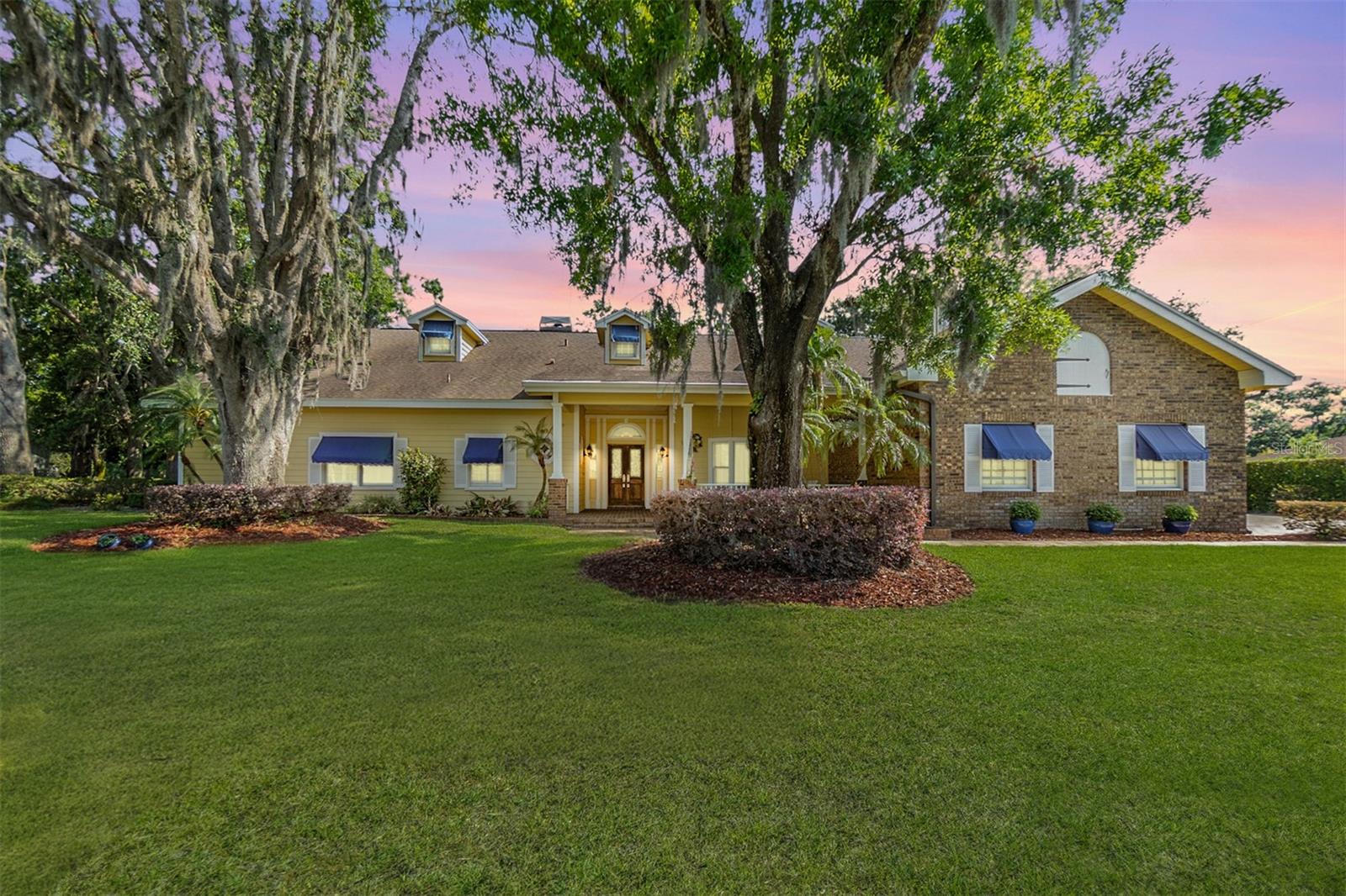 Tucked inside the gates of Cypress Run, this one-of-a-kind custom estate blends timeless craftsmanship with luxury living on a private, meticulously landscaped homesite. Set on just under 3/4 of an acre with panoramic views of the surrounding preserve and fairways, this 3-bedroom, 3 full bath, 2 half bath masterpiece showcases exceptional attention to detail across every inch of its 4,000+ square feet of living space. A stately drive welcomes you to the elegant façade, where lush greenery and a side-load 3-car garage with a custom-built workshop hint at the quality inside. Step through the double doors into a soaring foyer with custom tile inlays, decorative columns, and rich architectural moldings that frame the formal spaces. The expansive living room centers around a dramatic brick fireplace, surrounded by solid oak floors and flanked by French doors that open to the lanai. Ideal for entertaining, the chef’s kitchen is a showpiece featuring custom “Ali Kristy” cabinetry, exotic granite countertops, and granite flooring. The large center island anchors the space, accompanied by a six-burner Wolf dual-fuel cooktop, Sub-Zero refrigeration, copper-finished range hood, built-in warming drawers, and a walk-in pantry. The adjacent family room offers a relaxed yet refined setting with hickory flooring and a built-in bar boasting a granite-topped island, dual-zone wine fridge, and glass display cabinetry—perfect for hosting evening gatherings. The private master suite is a true retreat with vaulted ceilings, serene views, and a spa-style bathroom adorned with honey onyx countertops, a fully custom vanity, and a breathtaking curved-glass walk-in shower that feels like a work of art. Each guest suite offers its own unique design and private bath access, while a dedicated office, formal dining room, and oversized laundry room ensure both function and comfort. Step outside to your private outdoor sanctuary where a resort-style screened pool and lanai are surrounded by lush tropical foliage, an extended paver deck with room for a fire-pit area, a beautiful fenced in yard, shaded by mature oak trees, and tranquil natural golf course views with no rear neighbors in sight. Large Laundry Room with built-in cabinets and utility sink. You will love the large 3-Car Garage with Epoxy Flooring and tons of storage. Plenty of room to have a workshop, park your cars and golf cart. Whole House Water Softener, Upgraded Irrigation System can be controlled by phone. Cypress Run is a guard-gated community known for its championship golf course, tennis facilities, elegant clubhouse, and vibrant social calendar—all minutes from the Gulf coast beaches and Tampa’s top destinations. This estate is more than a home—it’s a statement in luxury, craftsmanship, and lifestyle.