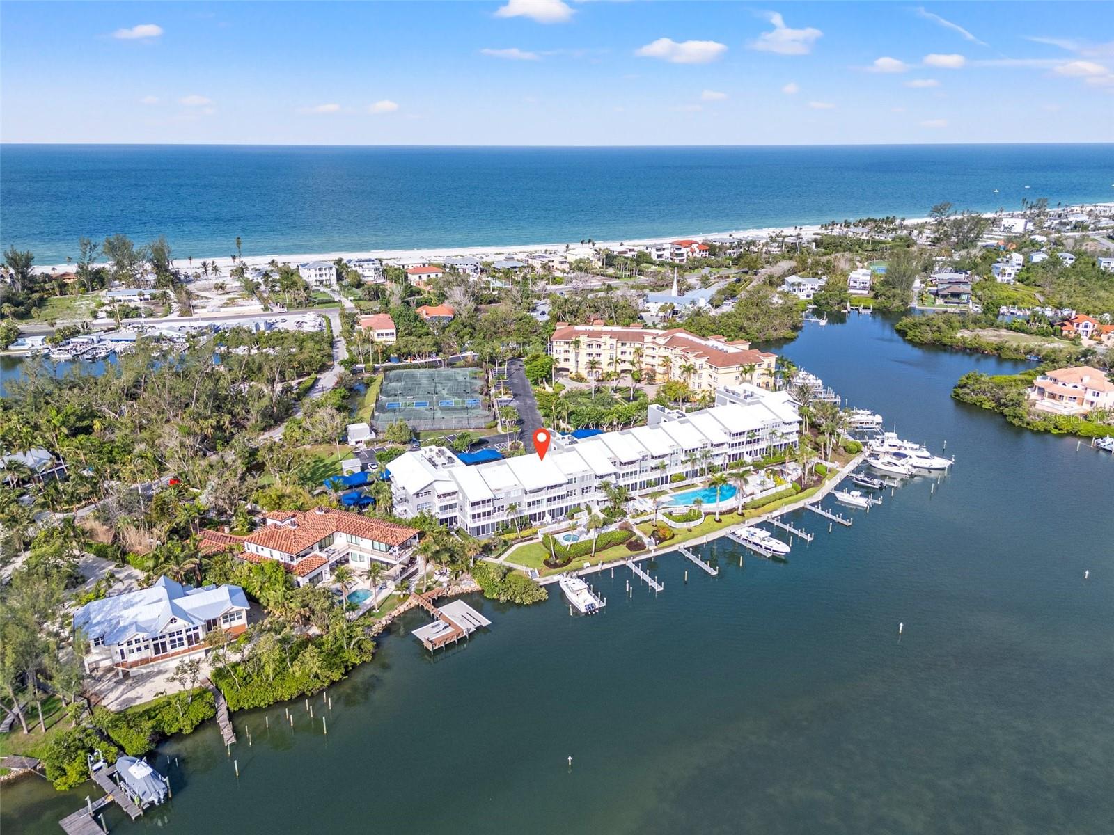 Paradise at Harbour Villa Club – Waterfront Luxury with a boat slip on Longboat Key! Enjoy this condo year-round or rent it weekly when you cannot be there- you choose! Discover this fully renovated 2BR/2BA condo with panoramic views of the gorgeous Sarasota Bay. Bright and spacious, the open floor plan features soaring 9 ft ceilings, custom finishes, a gourmet kitchen with top-of-the-line appliances and a sleek wet bar. The primary suite offers stunning water views, dual closets, and a spa-inspired bath. The second bedroom is spacious and set apart from the primary. Step into the enclosed lanai for breathtaking 180° water views and added living space— perfect for relaxing or entertaining. This unit comes with a deeded 40' boat slip #3 which features upgraded power and plumbing, new wraps, caps, marine grade bumpers and a deck box- a rare bonus that can accommodate a 55' vessel! Harbour Villa Club is nestled in a quiet corner, and you can walk or bike to the beach, area restaurants, and beloved Harry's Corner Store. This is a pet friendly community with covered parking, storage, elevators, kayak and bike storage, private dock, heated pool, tennis/pickleball courts, grills and beautiful landscaping. Weekly rentals allowed. Call today!
