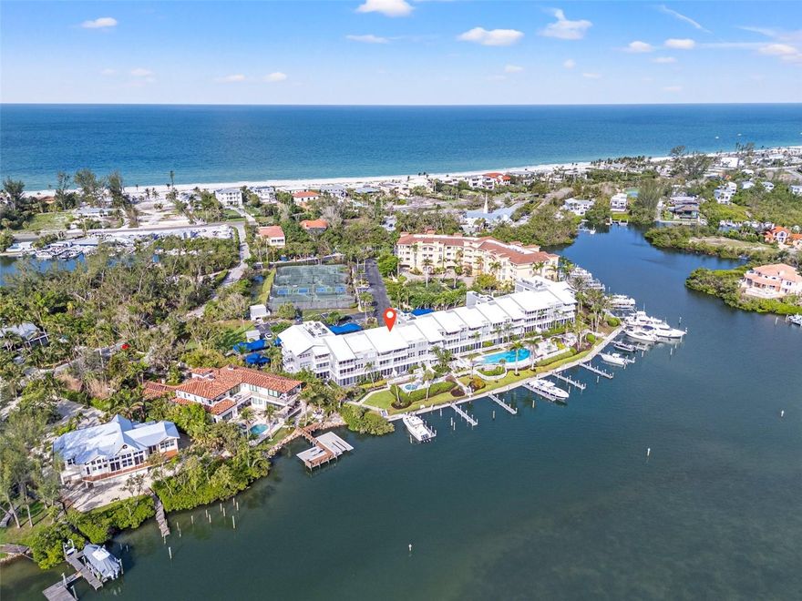 Paradise at Harbour Villa Club – Waterfront Luxury with a boat slip on Longboat Key! Enjoy this condo year-round or rent it weekly when you cannot be there- you choose! Discover this fully renovated 2BR/2BA condo with panoramic views of the gorgeous Sarasota Bay.  Bright and spacious, the open floor plan features soaring 9 ft ceilings, custom finishes, a gourmet kitchen with top-of-the-line appliances and a sleek wet bar. The primary suite offers stunning water views, dual closets, and a spa-inspired bath. The second bedroom is spacious and set apart from the primary. Step into the enclosed lanai for breathtaking 180° water views and added living space— perfect for relaxing or entertaining. This unit comes with a deeded 40' boat slip #3 which features upgraded power and plumbing, new wraps, caps, marine grade bumpers and a deck box- a rare bonus that can accommodate a 55' vessel! Harbour Villa Club is nestled in a quiet corner, and you can walk or bike to the beach, area restaurants, and beloved Harry's Corner Store. This is a pet friendly community with covered parking, storage, elevators, kayak and bike storage, private dock, heated pool, tennis/pickleball courts, grills and beautiful landscaping.   Weekly rentals allowed.  Call today!