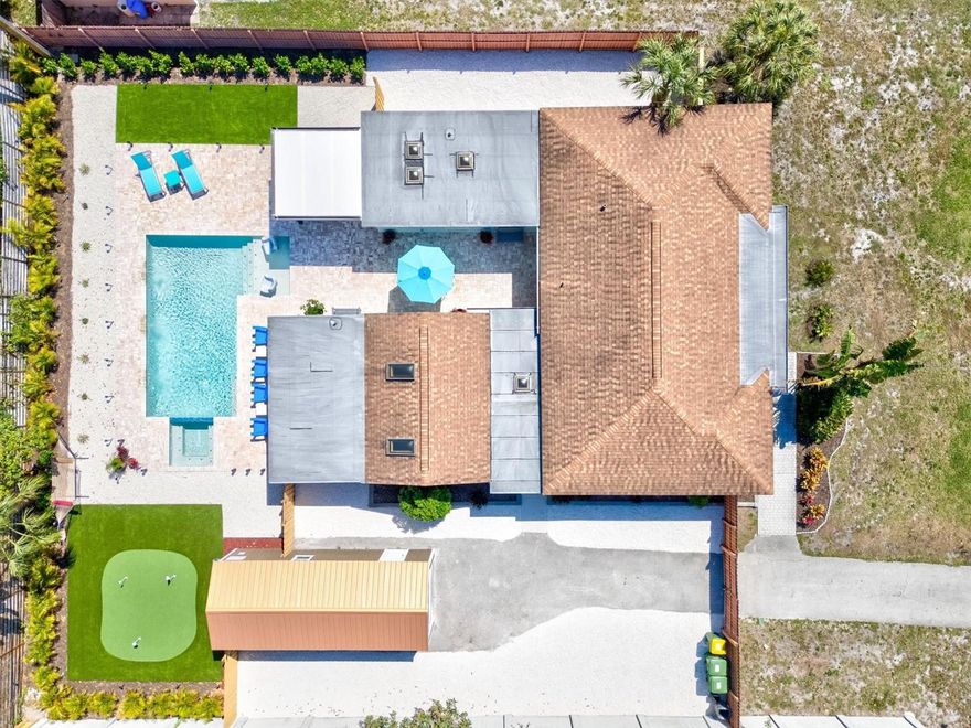 Welcome to the Ringling Retreat, a luxurious family compound in the heart of downtown Sarasota. The property sits just a few blocks from the East end of Main Street downtown and is perfectly walkable to the Legacy Trail, Payne Park, & a number of shops & restaurants. A screened entryway in the front greets you before stepping through the front door into a light and bright living area with views out to the new heated pool & generous seating including a queen sleeper sofa & two club chairs. A 65 inch mounted tv in this room w/ complimentary streaming services is accessible from the living room as well as the 3 stools at the breakfast bar separating the living space from the designer kitchen. The kitchen offers SS appliances & European style cabinets that are all labeled for your convenience & offer soft close hardware. Adjacent to the kitchen is a large dining area with seating for up to 12. The main house offers 3 large bedrooms & 2 well appointed bathrooms. The bed configuration is as follows: Bedroom 1 is just off the living room and is separated by french doors with privacy curtains. This room offers sleeping for up to 4 guests w/ two stand alone twin beds as well a twin over twin bunk bed. An open shelf closet, nightstand and mounted tv complete the set up. Bedroom 2 is located on the Master wing of the house with good separation from the Master bedroom and with easy access to the guest bathroom. This room offers a queen bed with two nightstands, a dresser and a large reach in closet. A large flat screen tv sits on top of the dresser. The Master bedroom is huge and offers a king bed with two nightstands, a dresser and a mounted tv on one of two shiplap accent walls. The Master has a zen feel and offers a large walk in closet, separate water closet/toilet area, and a recently remodeled spa-like bathroom with tiled shower, and double vanity sinks. Access to the courtyard & pool area is available from the Master. Step beyond the kitchen & dining area to an exterior covered breezeway to find a laundry closet to the right as well as a beach essentials closet to the left. The keypad enabled door between both closets grants access to the guest house which features a full living room w/ two large sofas including a queen pullout sleeper sofa as well as two club chairs. Adjacent to the living area is a full kitchen & eat-in kitchen area as well as a 2nd washer & dryer. Beyond the living space is a large bedroom w/ King bed, 2 night stands & mounted flat screen. This 2nd Master offers a walk in closet & full en suite bathroom. Beyond the breezeway & into the courtyard you'll find a large glistening pebble tec heated saltwater pool w/ an in-ground heated spa and large sun shelf that allows you to stay dry with your toes in the water. Two in-pool club chairs offer cupholders for your cold beverages as you soak up the Sarasota sunshine. Need some shade? We installed a Miami Dade hurricane rated patio with covered roof and an outdoor kitchen and bar area offering ample counter space and cabinetry, a mini fridge, and a premium 40" propane grill. 4 stools face the mounted TV so you can watch the game while your loved ones play nearby. Outdoor dining can be had either at the outdoor kitchen bar or the dining table with seating for 8 under a teal Sunbrella.  On the far side of the pool you'll find a gorgeous putting area for golf enthusiasts and children alike. New landscaping and landscape lighting make this feel like a resort at night.