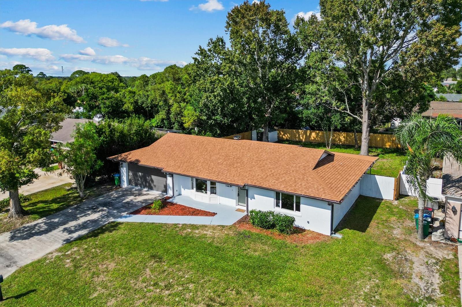 A BREATH OF FRESH AIR! This home has been updated with care, quality, and style, with functionality features everywhere you look. Showcase trim work and practical carpentry features give this home a ton of character and livable convenience. A beautiful bay window adds to the curb appeal and arrival, while adding natural light into the great room. The home has a split floor plan with the primary suite and 2nd bedroom with hallway bathroom are on one wing of the home. The 3rd bedroom or private office space with a full-sized closet is on the opposite side of the home. 450 square foot "Florida Room" interior space is heated and cooled, with major opportunity to accommodate a multitude of preferences. Pool table, craft space, bar room, game room, work from home space, etc. Geometric shelving built-ins give some additional flavor and add to the personal-touch potential of the home. 2-car garage! Washer and Dryer included. Updated windows and roof. Entire home including the 450-sqft space is all under one roof-type. Bring your toothbrush! This home needs nothing but a loving new owner. Amazing location in Deltona with major convenience to I-4 exit. This home also rests on a particularly nice street with lovely homes around it. Fully fenced big backyard. Two big Shade trees in the back.