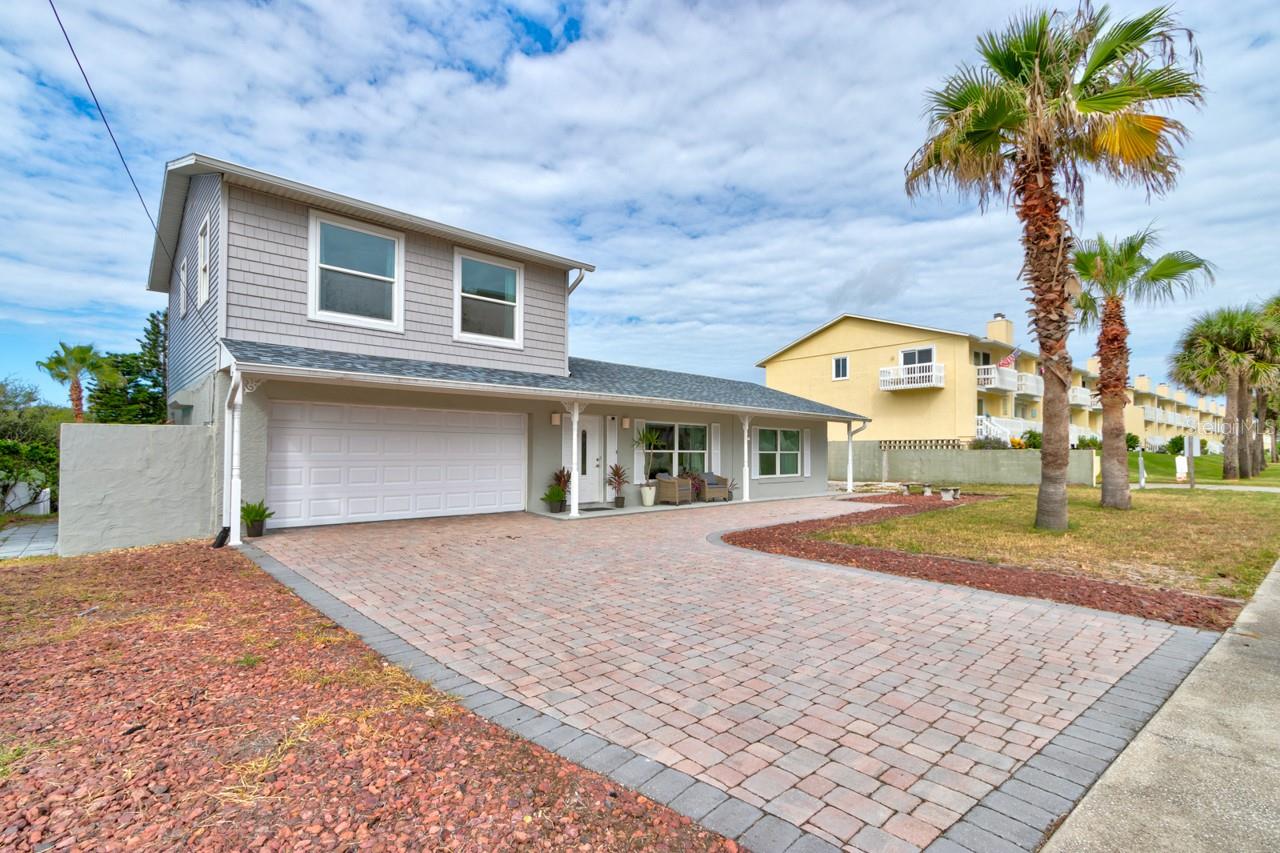 Pack your swimsuits! Welcome to your beachside home with public beach access across the street! This cozy & spacious home is the 2nd lot from the ocean & boasts 4 bedrooms, 2 1/2 baths with a 2-car attached garage. Kitchen has beautiful solid wood cabinets, granite countertops, stainless steel appliances, and tile floor. Main floor is a split-plan with primary suite on the north side of home with a walk-in closet as well as an additional closet & the en-suite bathroom is equipped with a large, jetted tub and separate shower. Bedroom 2 is on the south side of home with wall-to-wall storage closet. This room large enough to place multiple beds/bunkbeds for the visiting guests! Living room as well as a huge great room for dining/sitting room with fireplace for ample entertaining space and a half bath as well. Upstairs you will find 2 additional spacious bedrooms, each with 2 closets and the 2nd full bath. 2 closets in each bedroom and a peak at the ocean from the one!! Partial basement and whole house attic fan.
