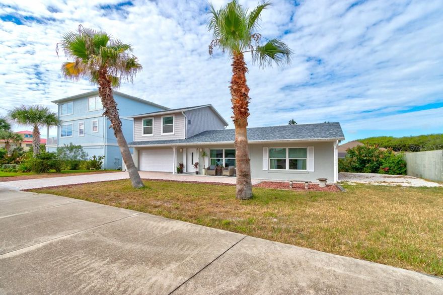 Pack your swimsuits! Welcome to your beachside home with public beach access across the street! This cozy & spacious home is the 2nd lot from the ocean & boasts 4 bedrooms, 2 1/2 baths with a 2-car attached garage. Kitchen has beautiful solid wood cabinets, granite countertops, stainless steel appliances, and tile floor. Main floor is a split-plan with primary suite on the north side of home with a walk-in closet as well as an additional closet & the en-suite bathroom is equipped with a large, jetted tub and separate shower. Bedroom 2 is on the south side of home with wall-to-wall storage closet. This room large enough to place multiple beds/bunkbeds for the visiting guests! Living room as well as a huge great room for dining/sitting room with fireplace for ample entertaining space and a half bath as well. Upstairs you will find 2 additional spacious bedrooms, each with 2 closets and the 2nd full bath. 2 closets in each bedroom and a peak at the ocean from the one!! Partial basement and whole house attic fan.