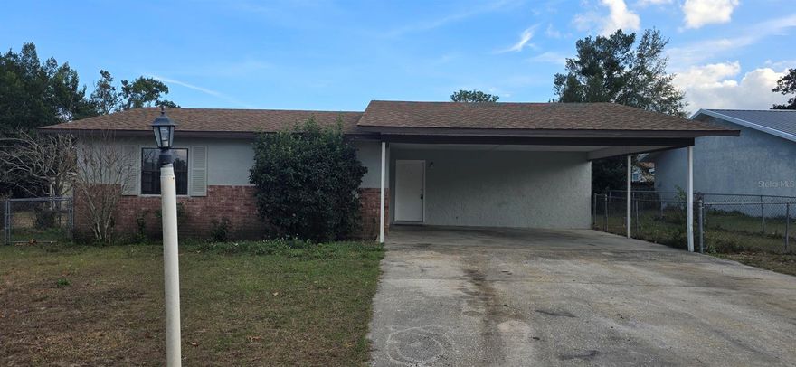 3 bed, 2 bath home with a large 2-car carport.    Tile and laminate floors throughout.  Chain link fenced backyard.  Close to shopping and dining.