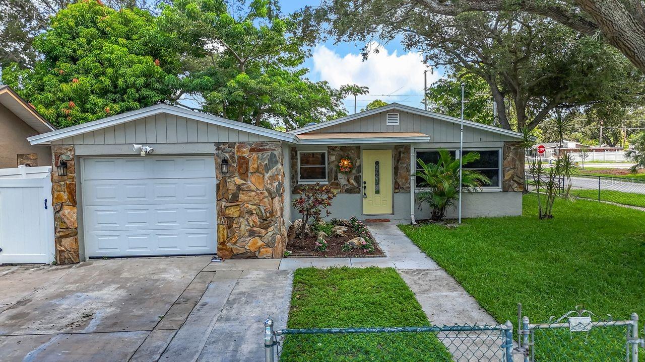 A Truly Charming Home 3-bedroom with 2 full baths. Not in a Flood Zone. No HOA. No CDD. Brand New Roof, tile flooring throughout, corner lot with a lot of shady trees. Two driveways with separate entrances. Layout offers privacy but has an open floor plan with plenty of space for entertaining family and friends! Kitchen the heart of the home offers stone countertops, brown kitchen cabinets, stainless steel appliances, lots of pantry space, and an eat in kitchen offering sliding glass doors opening the home to the fully fenced in back yard with a covered porch area great for grilling and entertaining. Primary bedroom with plenty of closet space , over head ceiling fan with lighting and newly updated bath. Second bedroom also offers plenty of closet space, over head ceiling fan with lighting. Second bath has been newly updated. Single car garage. Shed in the backyard. Close to shopping, restaurants and beaches. Looking forward to hearing from you soon.