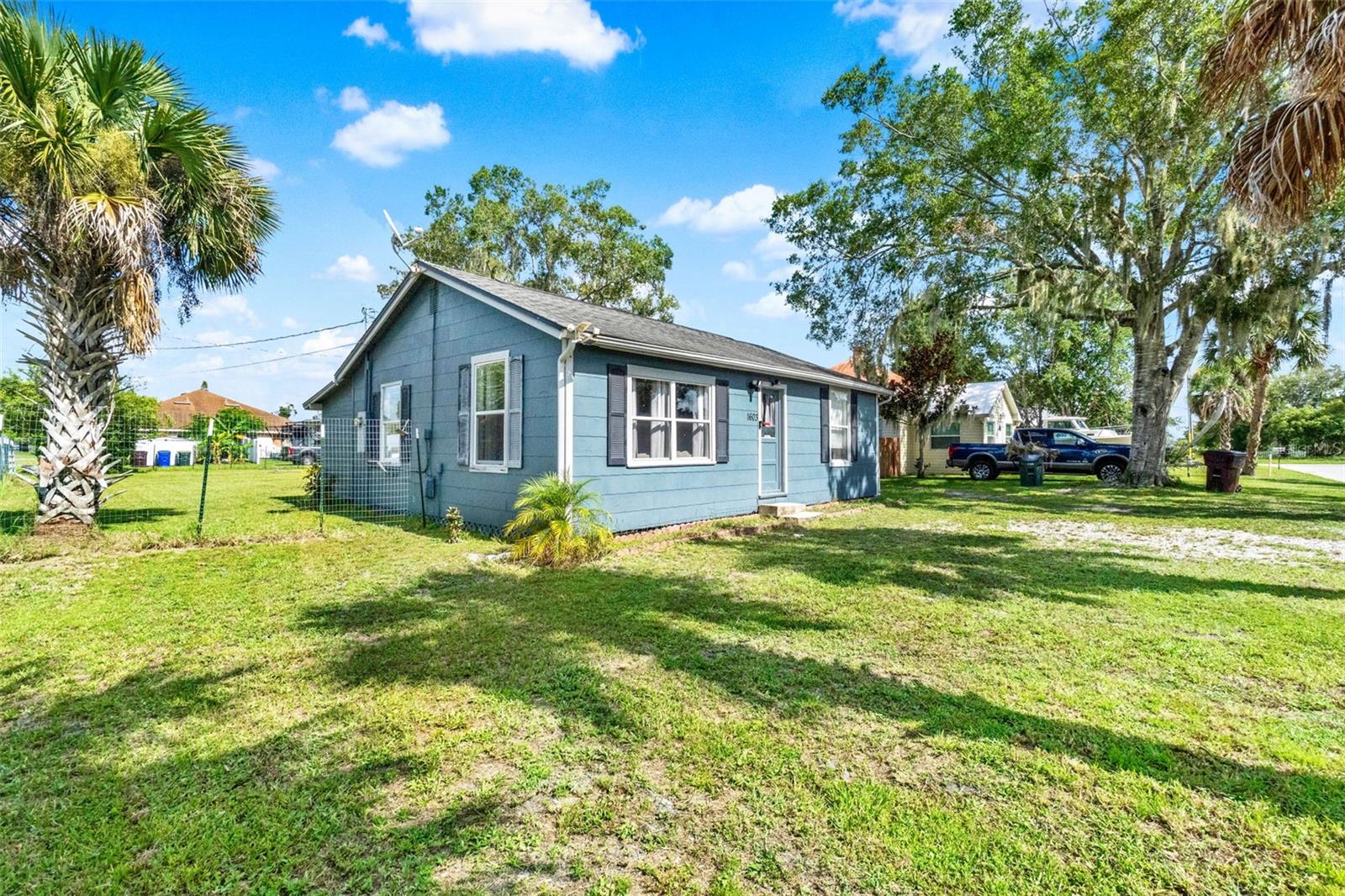 Own a Piece of History in the Heart of Saint Cloud! This charming 2-bedroom, 1-bath home was built in 1920 and sits on a fully fenced 10,498 sqft corner lot, offering plenty of space to enjoy or expand. Inside, you'll find a warm living area with wood flooring, carpeted bedrooms, and tile in the kitchen and bathroom. The covered back porch is perfect for relaxing or entertaining. Located just minutes from Lakefront Park, you'll enjoy easy access to walking trails, playgrounds, a marina, and beautiful lake views. You're also close to vibrant downtown Saint Cloud, known for its local shops, cafés, restaurants, and community events that give the area a unique small-town charm with a lively atmosphere. Whether you're a first-time homebuyer, downsizing, or investing, this home offers timeless character and a fantastic location in one of Central Florida’s most exciting and evolving communities.