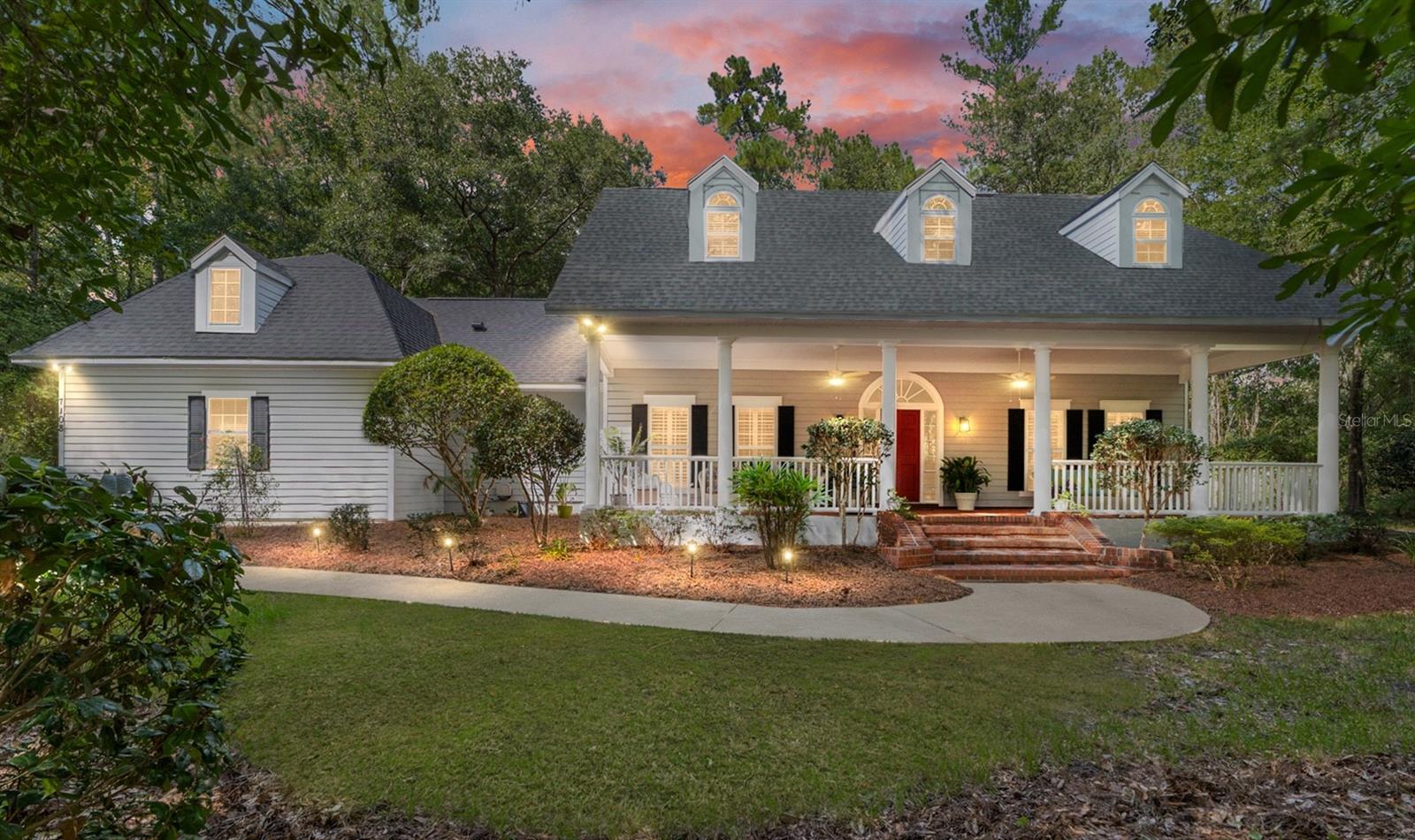 Asheville meets Gainesville! This storybook Southern charmer sits tucked beneath a canopy of trees, with a 40' front porch that feels like it was made for rocking chairs and long conversations. The large entry welcomes you into a home that balances classic style with everyday comfort. Inside, natural light filters through plantation shutters, highlighting warm wood accents and a thoughtful floor plan (see floor plan in photos) - including a large MUDROOM/drop-zone and walk-in pantry.
The living spaces are open yet inviting, with room for gatherings both big and small. The kitchen flows easily into the heart of the home, offering a place to cook, connect, and create memories. Step outside to enjoy the peaceful setting — on your 38' screened lanai, surrounded by a FULL ACRE of greenery and the quiet of nature, yet close to all that Gainesville has to offer (3 minutes to PUBLIX, Santa Fe College or I-75, 9 minutes to North Florida Hospital, 13 minutes to UF's Levin College of Law, 15 minutes to "THE SWAMP").
Downstairs the Primary Suite opens to the covered and screened lanai that stretches across the back of the of the home, perfect for relaxing at the end of the day. Upstairs, the guest bedrooms and bathrooms feature dormer windows add charm and character. Brick steps, a winding walkway, and established landscaping complete the picture, making this home as welcoming outside as it is inside.
The GATED community of "The Sanctuary" is just that - a place that feels both timeless and unique. Come experience it in person!
Video: https://youtu.be/38oS_kjrgNo