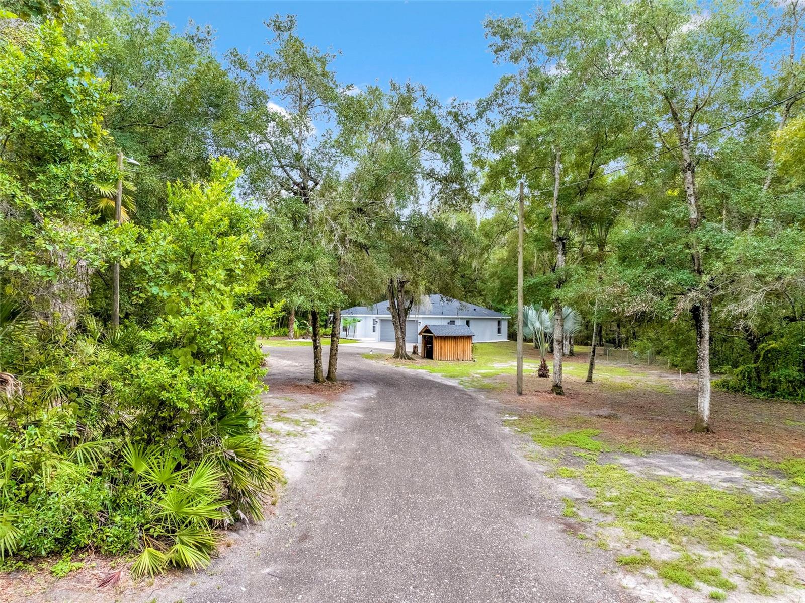 One or more photo(s) has been virtually staged. One or more photos have been virtually staged. Lowest priced block home on 2.5 acres ZONED Agricultural (AG). This beautifully updated 1,525 sq. ft. home, built in 2007, offers three bedrooms, two bathrooms, and a spacious two-car garage. The property combines modern updates with endless outdoor possibilities—perfect for those who dream of space, privacy, and even farm animals. Recent improvements include a brand new roof, a brand new A/C system, a new septic tank, fresh paint inside and out, new granite countertops in the kitchen and bathrooms, and new carpet in all three bedrooms.
Step inside to find a large open living and dining room combo with a brand-new wall-mounted TV for the new owners. The kitchen sits straight ahead, featuring real wood cabinetry with nickel hardware, granite countertops, and newer stainless steel appliances. Down the hallway are two guest bedrooms with new carpeting, remote-controlled ceiling fans, and standard closets, along with a modestly updated guest bathroom featuring a tub/shower combo, single-sink granite vanity, and updated lighting. On the opposite side of the home, the private master suite offers two walk-in closets, a dual-sink granite vanity, a walk-in shower, a linen closet, and a private commode with ventilation.
Sliding glass doors from the living area open to a fully screened lanai with a new outdoor ceiling fan, overlooking the expansive 2.5-acre private retreat. The property includes multiple cleared areas, ready for metal buildings, pole barns, or other structures. Additional highlights include a newly installed asphalt millings driveway leading to an oversized concrete drive, a private well with a dedicated well house, and water lines throughout portions of the property for gardening, landscaping, or livestock. With agricultural zoning, you can truly make the land your own.
This home offers the perfect blend of modern comfort, acreage, and affordability. With major updates already completed, it is truly a turn-key property ready for its next owner.