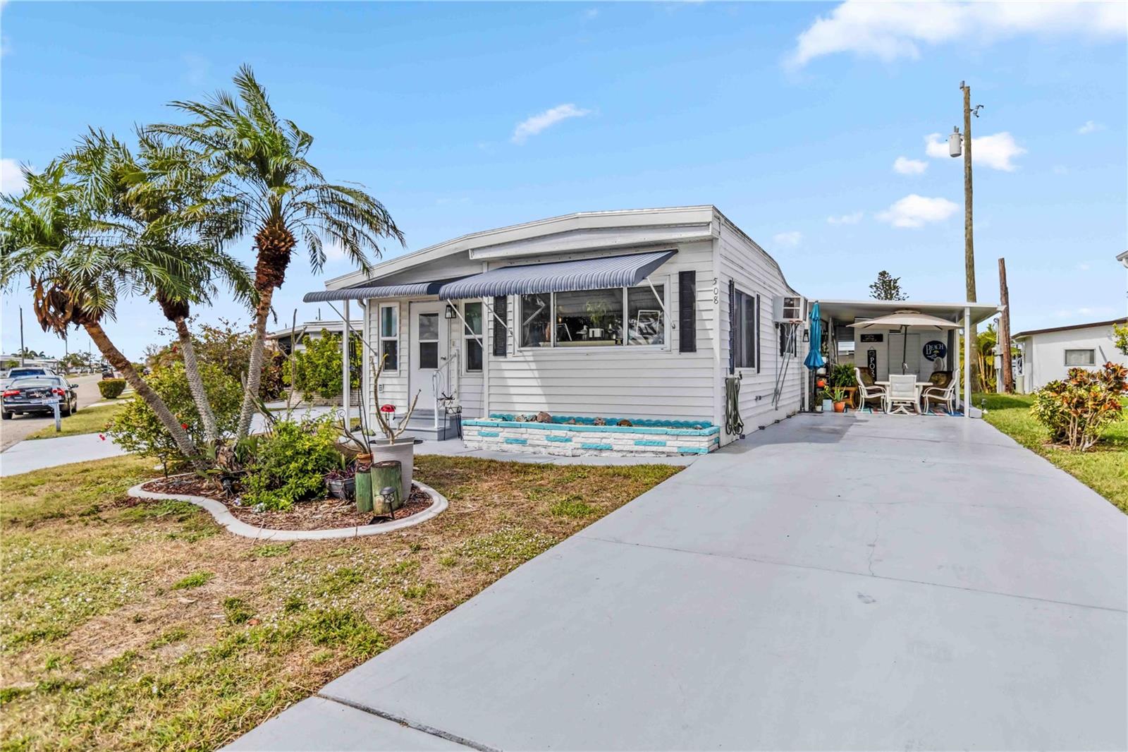 PRICE IMPROVEMENT AND SELLERS ARE MOTIVATED! WE WILL REVIEW ALL OFFERS. This beautifully updated 3-bedroom, 2-bathroom mobile home, boasting over 1000 square feet of living space, is located in the desirable and meticulously maintained Harbor Cove Community of North Port, Florida, with direct access to the Myakka River. This home boasts an open-concept kitchen, spacious living areas, impact windows, and laminate flooring throughout. A bonus room provides space for a small office, and a small workshop is also included. Enjoy the vibrant Florida lifestyle with access to the community marina, pools, and recreational facilities. The home has a low land lease fee of just $99/year. Come experience the best of Florida living! Additional amenities include an optional North Rec Center membership for $150/year and optional storage space for an additional $700/year.