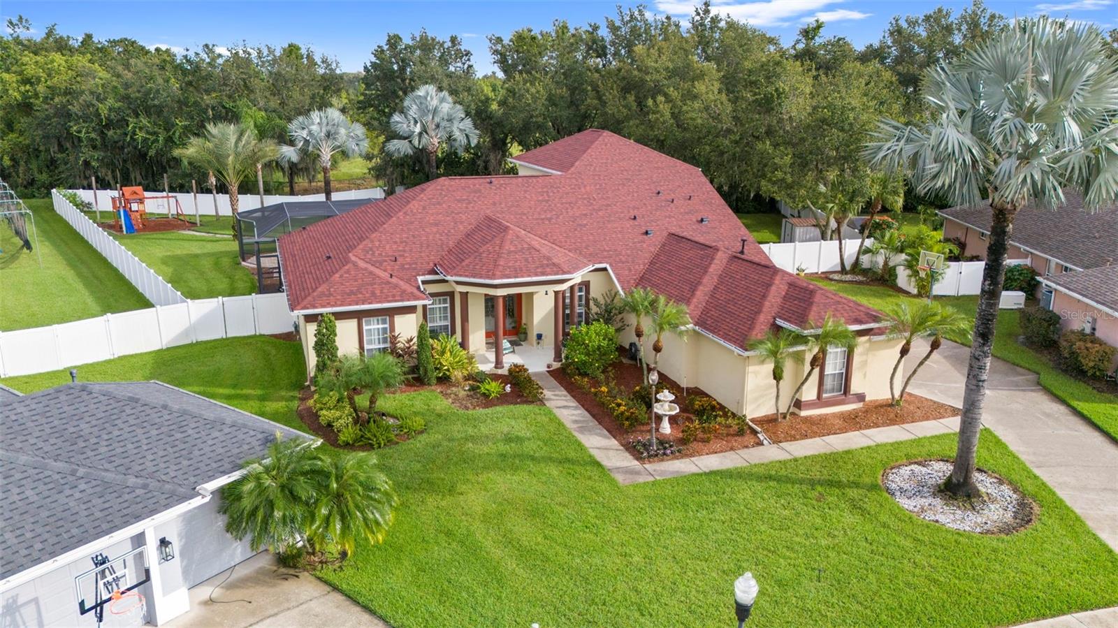 Step inside this beautifully maintained home on Mossy Timber Trail, ready for its next great family! The oversized screened pool (25,000 gallons, resurfaced 2016) features updated equipment with smart controls, plus a half bath, outdoor shower, and retractable patio screen. The backyard is built for entertaining with room to grill, relax, and play—featuring a custom playground with walking path and full fencing for privacy. No rear neighbors thanks to the easement behind the property!
Inside, the split floor plan includes a spacious master suite with a remodeled bathroom in 2023 with whirlpool tub, walk-in shower, and marble double vanity. The central kitchen offers tall cabinets, granite counters, pantry, and smart appliances including a Wi-Fi wall oven with air-fry features and a doble drawer WiFi enabled dishwasher. A breakfast nook and large family room with gas fireplace complete the main living space. Additional bedrooms share a remodeled bath (2025), plus laundry with new smart washer/dryer. Upstairs: guest suite, full bath (2025), and a large game/media room.
Conveniently located in a family-oriented community zoned for top-rated schools with easy access to Tampa, Lakeland, and Orlando. Schedule your showing today!