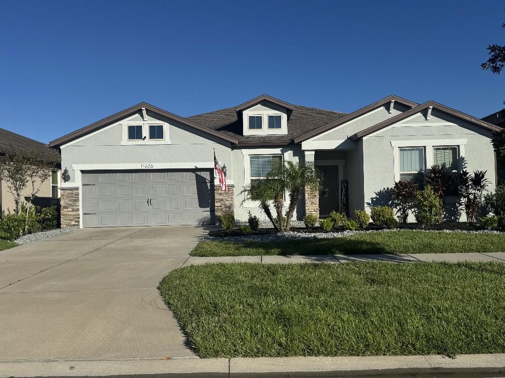 In the heart of South Fork III, this beautifully maintained 2018 home offers the perfect blend of space, warmth, and modern comfort. With 3 bedrooms, 2.5 baths, and a flexible bonus room, it is designed for both relaxation and everyday living. The open floor plan flows through tile-lined spaces into a bright living area where a three-panel pocket sliding door opens fully to an extended screened lanai. Evening light fills the home as sunsets paint the sky, creating a calm and inviting atmosphere.
The kitchen features quartz countertops, a deep farmhouse sink, new appliances, a separate wall oven and cooktop, and a sunny breakfast nook overlooking the backyard. The primary suite includes an extended layout with his-and-hers vanities and a spacious walk-in closet. A 3-car garage, mudroom, and laundry room add convenience and storage.
Outside, enjoy low-maintenance salt and pepper granite landscaping, a backyard with perfect space for a future fire pit where friends can gather under the evening glow, and neighbors who make the community feel like family. This home is turnkey, located on a quiet street, and neighbors who make the community feel like family and ready for its next owner to begin a new chapter.