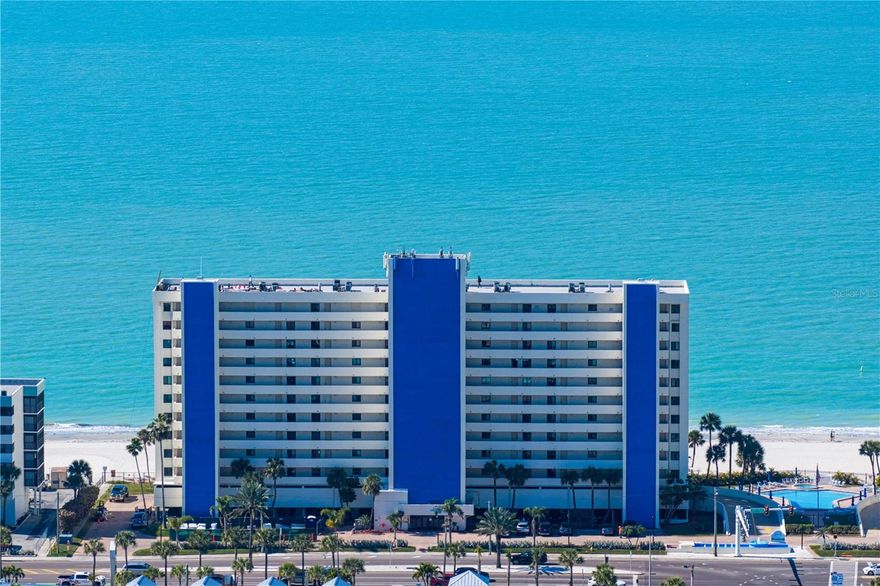 Welcome home to your own slice of paradise in this beautiful Madeira Beach waterfront
two-bedroom, two-bath residence. From the moment you step inside, you’re greeted by
sweeping views of the Gulf that immediately set the tone for relaxed coastal living. Tile
flooring throughout the home enhances the coastal aesthetic while offering durability
and easy maintenance. The open-concept kitchen features stainless steel appliances
and bar seating — perfect for gathering after a day in the sun. The living area flows
seamlessly to the expanded balcony, where breathtaking sunsets and salty breezes
become part of your everyday routine. A convenient storage closet on the balcony
keeps all your beach essentials neatly tucked away, and hurricane shutters provide
added peace of mind.
The spacious primary suite offers private balcony access, a generous walk-in closet with
closet organizers, and an en-suite bath with dual vanities. The second bedroom
comfortably accommodates bunk beds or two twins and includes smart in-wall storage.
An in-unit laundry room makes cleaning up after beach days effortless, and additional
pantry and storage space ensure everything has its place. There is also a dedicated
storage unit on the same floor for added convenience. Residents enjoy direct beach
access along with resort-style amenities including a pool, shuffleboard, fire pit, and tiki
hut — truly embracing the “no shoes, no shirt, no problem” lifestyle. The community also
allows short-term rentals with a two-week minimum, offering excellent flexibility for
personal use while generating income when you’re not in residence. Schedule your
private showing today and experience the best of Madeira Beach living.