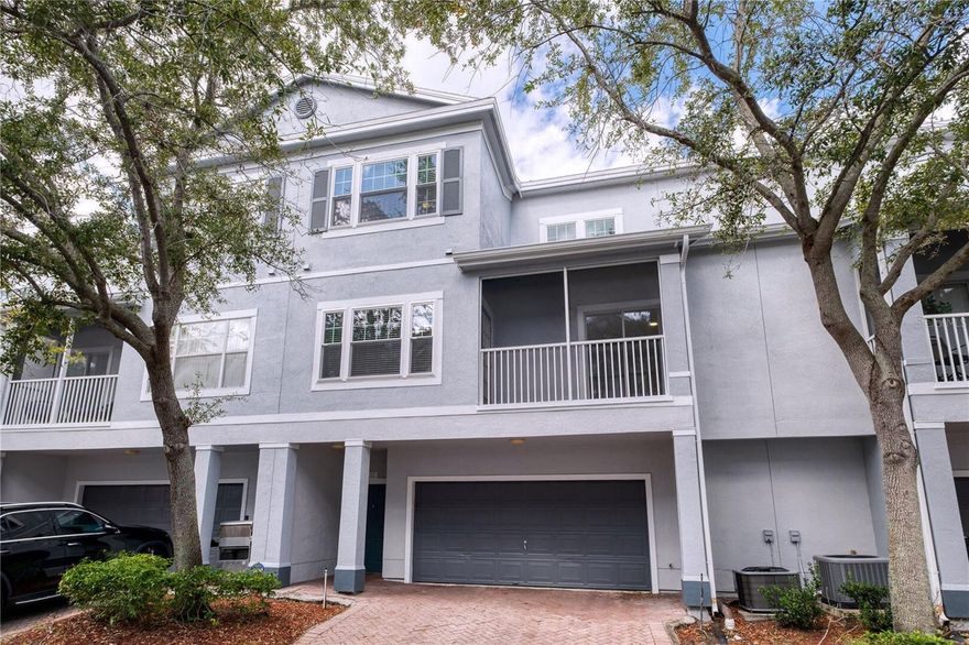One or more photo(s) has been virtually staged. Located on the prettiest tree-lined street in The Estates at Park Central, this is the condo/townhome you’ve been waiting for. Seller has just installed NEW DOUBLE PANE WINDOWS throughout, letting the dappled sunlight filter through the treetops into all the living spaces and bedrooms. The first level offers an oversized 2-car garage with paver driveway large enough for another 2 cars. Entering the front door, a staircase brings you to the 2nd floor living space and kitchen, featuring solid surface counter tops, stainless steel appliances, and plenty of wood cabinets for the home chef. The spacious light and bright living/dining room with tile flooring even offers access through a french door to the screened-in balcony. Also on this 2nd level is the primary bedroom with en-suite, huge walk-in closet, and access through glass sliders to the balcony. The top level boasts two large bedrooms, both with walk-in closets and access to another full bathroom with walk-in shower.  
The community pool, just for “The Estates” townhomes section, overlooks the pond with fountain and is just a few steps away from your front door. 24/7 guard gated Park Central is a resort-style community centrally located just minutes from Millenia Mall, Universal Studios, Downtown Orlando, and major highways, making this home ideal for both owner-occupants or investors. The larger community offers access to multiple pools, tennis and basketball courts, fitness center, convenience store, pizzeria/restaurant, and sidewalks that provide scenic walks around the community’s lakes. The association takes care of the exterior, which was freshly painted this year, and the roof (replaced in 2021), providing you with easy living, along with Spectrum's ultra-fast 1GB high-speed internet which will be included in the monthly HOA starting January 2026.  Come see one of the loveliest townhouses and make it your own abode.