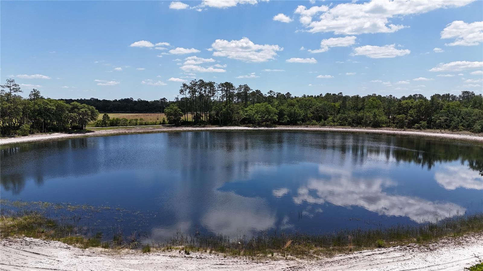 Waterfront Acreage in Marion County, Florida only 25+/- miles from Ocala and/or Gainesville • There are a total of 10 lots on this 114 acre rural development (Only 3 lots remain, inventory selling fast.). This listing is for lot 1...Additional parcels available (pics are of entire project and may not be site specific but all lots are similar) • Two Spring FED Ponds (10 acre & 3 acre) with White Sandy Bottom.• Gently Rolling pastures with Large Live Oaks/Pines around the Ponds • Private Limerock Drive off Hwy 318 in convenient NE Marion Co., FL • Minor Deed Restrictions to protect integrity of your investment but NO Hoa. • Zoning - A1 / Land Use - Rural Lands (1 unit per 10 acres). • Owner Financing Available... 10% down, 10.9%, 10 year amortization / 3 year Balloon, Payments $2,346/Mo. (Buyer pays all Closing Costs on Owner Financed Sales including Doc Stamps, Intangible Tax, Recording Fees, Title Insurance & $100 closing fee - total estimated to be approx. $4,600).