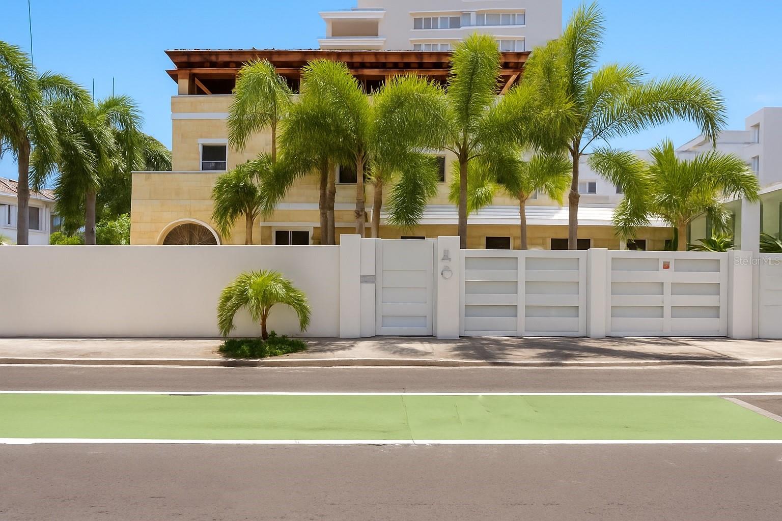 This one-of-a-kind private residence sits on the coveted Magdalena Avenue in Condado, offering the perfect blend of space, privacy, and prime location. Featuring 4,553 sq. ft. of interior living space across two levels and an additional 2,234 sq. ft. rooftop terrace.
On the first level, you are welcomed by a charming covered porch that opens into a bright, open-concept layout with a foyer, spacious family and living areas, a kitchen, dining room, and two bedrooms with two full bathrooms. The first level also features an impressive outdoor area with a pool, surrounded by a high privacy fence.
The property offers two separate entrances—one from Magdalena Avenue and another from Calle Santiago Iglesias—along with three covered carport spaces and additional uncovered parking.
The second level boasts four more bedrooms and a versatile den, ideal as a second living room, playroom, or home office. The expansive master suite includes a walk-in closet and ample space to create your own retreat.
The third level rooftop terrace is a true highlight: a covered wooden space with a bar area and half bath—perfect for entertaining or enjoying quiet evenings.
Additional features include a built in elevator and a full power generator.
This home is ideally located just two blocks from the park, and near top private schools, the beach, restaurants, grocery stores, and more—placing the very best of Condado right at your doorstep.