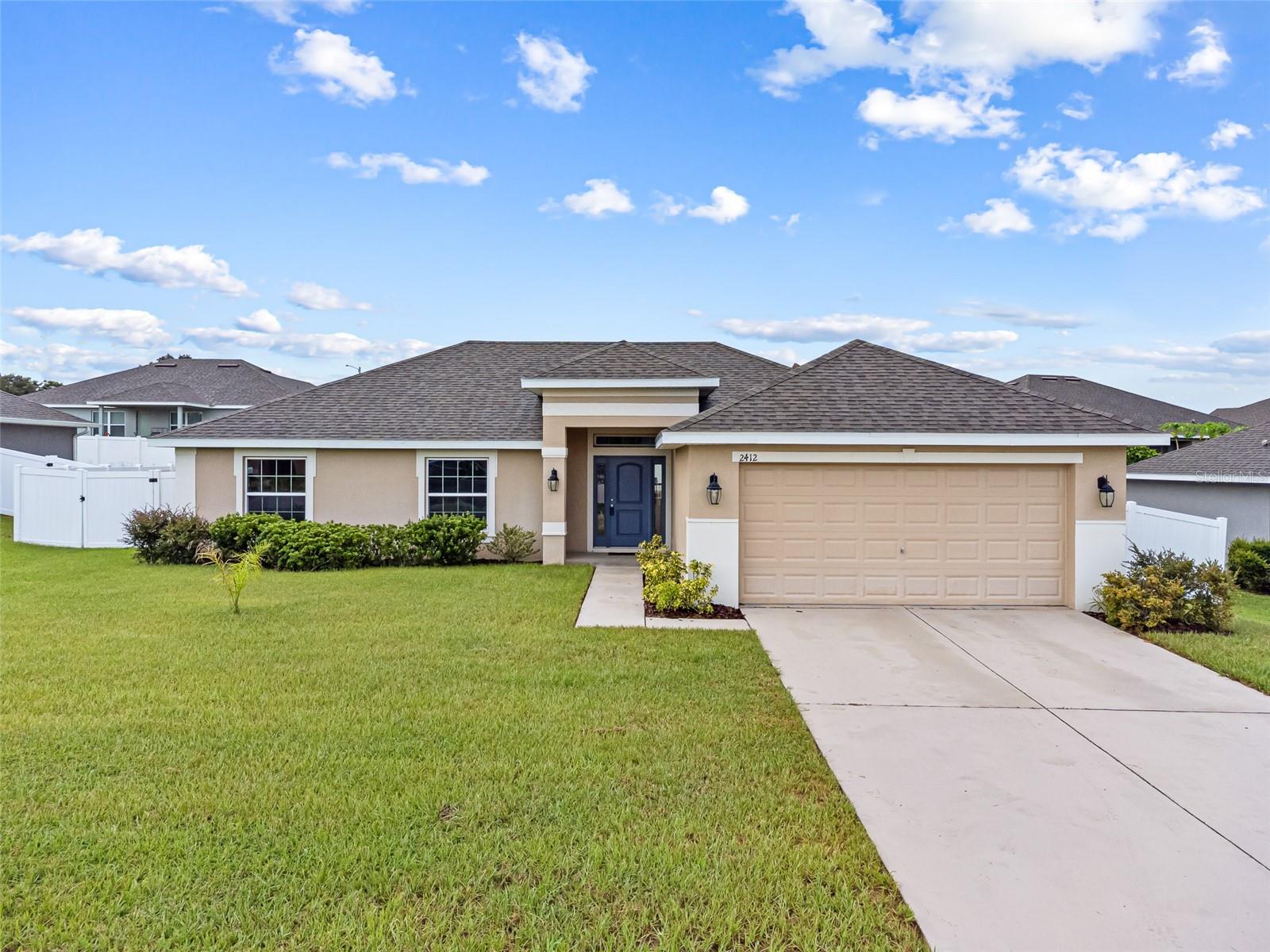 One or more photo(s) has been virtually staged. Don't miss an opportunity to own this 4 bedroom/2 bath home, built in 2018, with 1,756 sq ft heated living space. Natural Gas Community. Features a split bedroom, open floor plan, plenty of natural light, spacious living room with vaulted and tray ceilings perfect for your family and friends. The kitchen features a breakfast bar and hosts a copious amount of cabinet and counter space, perfect for cooking and storage. The master bedroom is 12' X 15' with an en-suite bathroom featuring plenty of cabinet space with doors and drawers, double sinks, separate shower and tub and large walk-in closet. The tiled open dining area is ample enough for an 8 person table. Observe the gorgeous tile flooring in kitchen, dining and laundry room. Fans in living room and master bedroom. Tankless Water Heater. Relax under the covered lanai. Backyard is large enough for a swimming pool. 6' Vinyl fencing is perfect for privacy. Front yard sidewalk is great for taking walks. Located 1.3 miles from Polk State College in Eagle Crest Subdivision. Centrally located close to quaint downtown, Legoland, restaurants, and shops. No CDD Fee's and Low HOA fees.