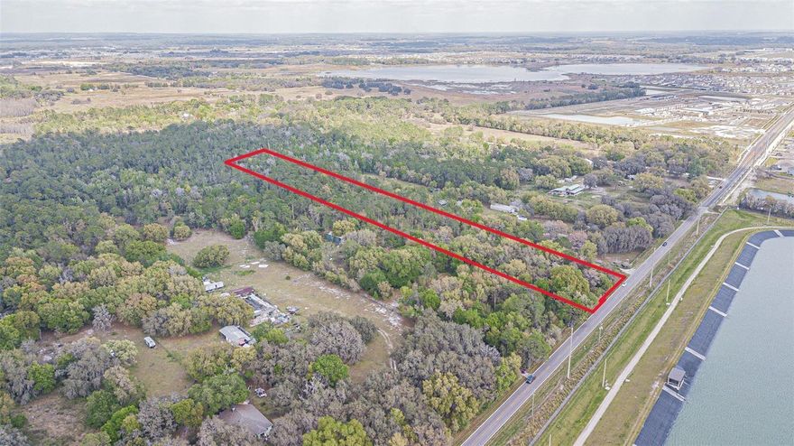 Opportunity to develop SFR or townhomes on 10-65 acres by combining with adjacent properties. Join with a potential 65 acres next door to get 750' on Elam Road and over 1,000' on Kenton Avenue, just a ½ mile away from the new, 56-bed Johns Hopkins All Children's hospital that broke ground and is expected to open in 2027.

Or existing AC zoning allows schools, solar farms, churches (religious facilities), and civic organization buildings. Special exception uses: cemeteries, golf courses, day-care centers, and private schools.

Nestled in the heart of the Community Hub Spa Zone in the thriving Connected City, this parcel is not just land; it's the gateway to your next success story. Seize the opportunity to redefine luxury living and urban convenience on this fantastic canvas. Imagine crafting a masterpiece that resonates with the pulse of progress – strategically rezone for higher density and watch as your vision springs to life. This prime location is a heartbeat away from the bustling Epperson Ranch, Mirada, and Watergrass developments, making it the epicenter of growth and vitality. King Lake, poised to evolve just a block away with a harmonious blend of homes and offices, sets the stage for a vibrant, interconnected community. Strategically positioned near the Interstate ramp at I-75, accessibility meets desirability, promising a seamless blend of urban convenience and suburban tranquility. 

The proximity to the county recreation center ensures your future residents will have their own haven of leisure and entertainment just moments away. Step into the embrace of nature with a conservation area adorned by majestic oak trees, providing the perfect backdrop for sustainable development and a touch of rustic charm. With large oaks dotting the landscape, the ambiance of the property is one of natural elegance, creating a serene haven for future residents. Approximately 5.28 acres of this sprawling 10-acre gem are ready to be transformed into a haven of townhome/mixed use excellence. Whether you envision a modern enclave or a charming community nestled within nature's embrace, the possibilities are as vast as the land itself. The potential for a seamless transition from vision to reality is unprecedented. However, let's not just talk about the acreage – let the figures speak for themselves. Buyers and buyers' agents, rest assured, as we provide transparent information. While approximately 5.28 acres are marked for development, the potential for density and the usable acreage is a matter that should be explored with the guidance of your own engineering firms. Your vision deserves nothing less than the most accurate and reliable information. Unleash your creativity, unlock the potential, and make your mark on Elam Road. This is more than just a piece of land; it's an investment in a future where innovation, nature, and community converge. Secure your piece of the Connected City today, and let the legacy of 30651 Elam Road begin! Buyers/Buyers Agents are not to rely upon any usable acreage or density estimates from listing agent or seller-utilize your own land consultant and/or engineer. *Address # not assigned yet. Join contiguous parcels next door for up to a 95 acre development opportunity.  Survey, wetland map and phase 1 reports completed.